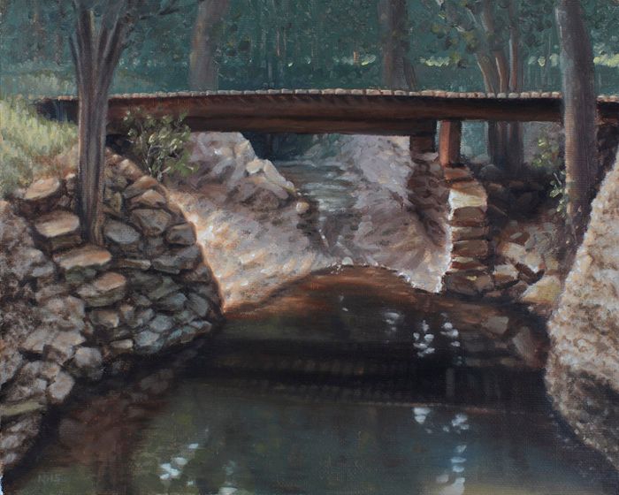 Oil painting of a narrow wooden bridge spanning a shaded creek, framed by rocky banks and dark green woodland.