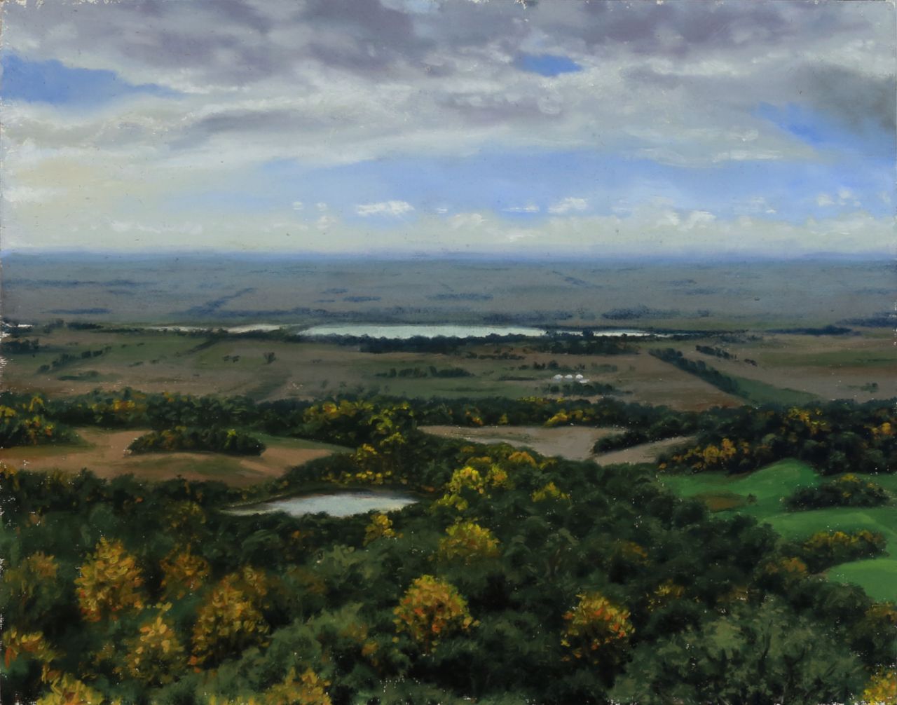 Realistic landscape oil painting by Nick Baxter of a view of distant flat North Dakota farmland under a bright blue cloudy sky, with clusters of trees and golden fall foliage, with 2 reflective ponds in the distance.