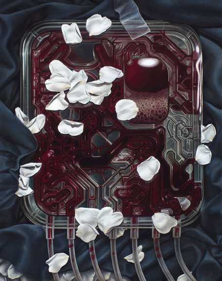 A translucent red mechanical panel with looping channels and dangling tubes lies on dark blue fabric, scattered with white flower petals.