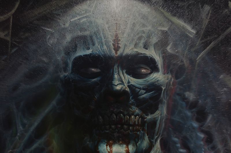 Close-up painting of a dark skeletal face with closed eyes, exposed teeth, and pale blue-white streaks radiating across a black background.