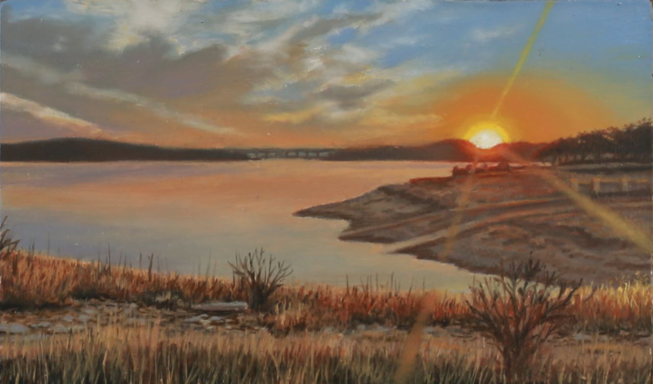Oil painting of an orange sunset over a lake, with distant hills, a bridge, rocky shoreline, and dry foreground grasses.