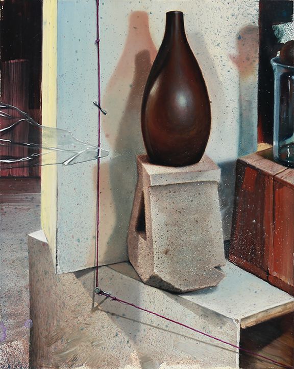 A dark brown vase rests on stacked concrete blocks amid pale panels, taut wires, and a partially visible glass jar.
