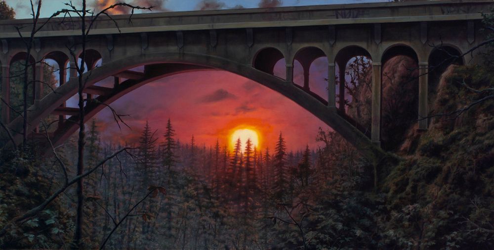 A concrete arch bridge spans a shadowy forested ravine, framing an orange sun setting behind silhouetted evergreens.