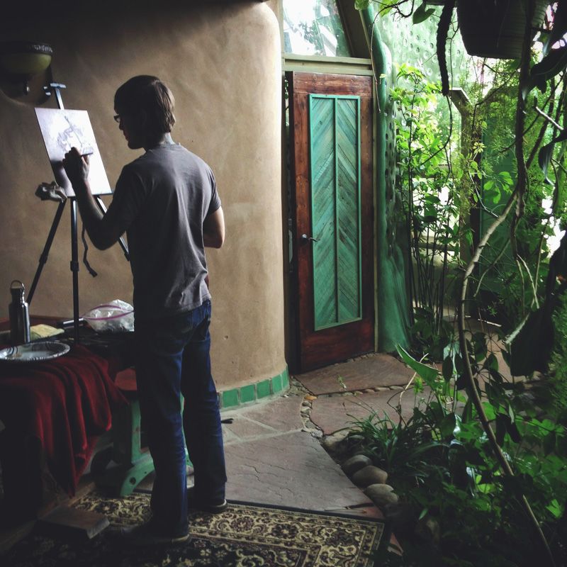 Painting in the inspirational interior of an Earthship.