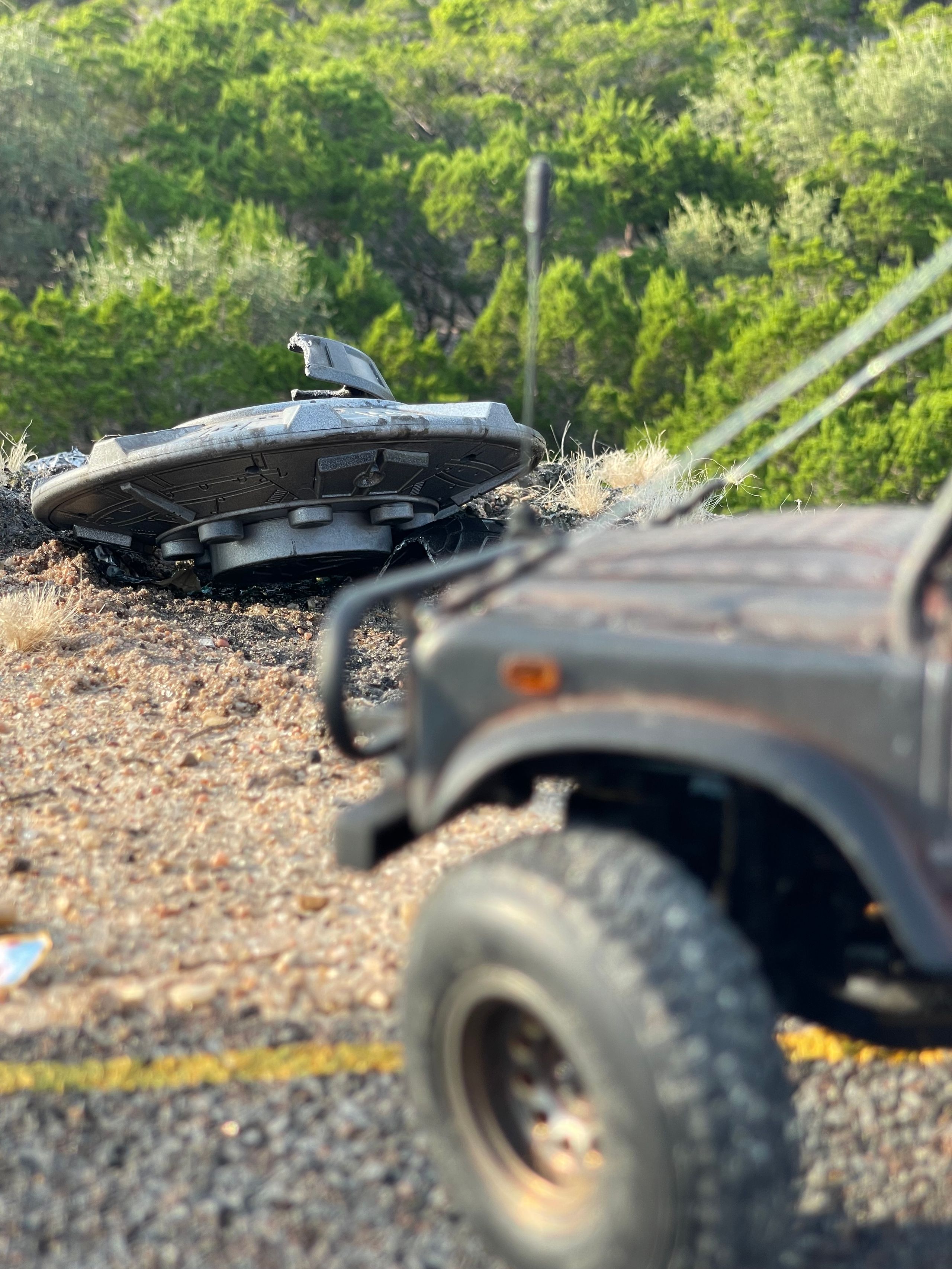 1/24 scale diorama with UFO depicting the Roswell Incident, with desert landscape made from found materials, real dirt and rocks, modeling supplies, with 1/24 scale rugged overlanding Land Rover Defender 110.