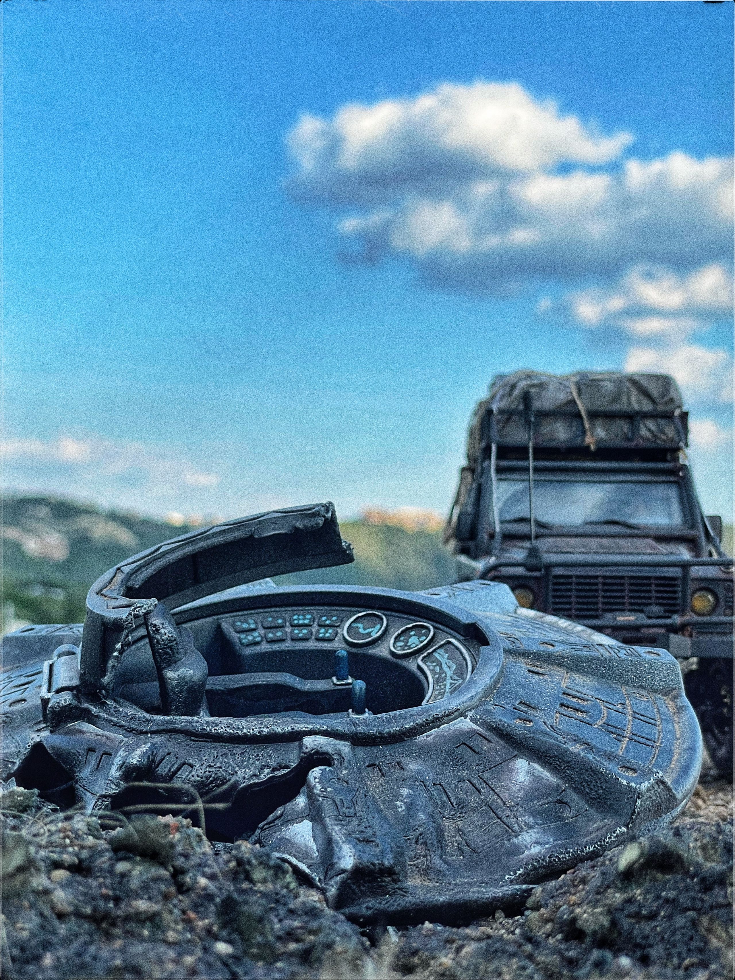 1/24 scale diorama with UFO depicting the Roswell Incident, with desert landscape made from found materials, real dirt and rocks, modeling supplies, with 1/24 scale rugged overlanding Land Rover Defender 110.