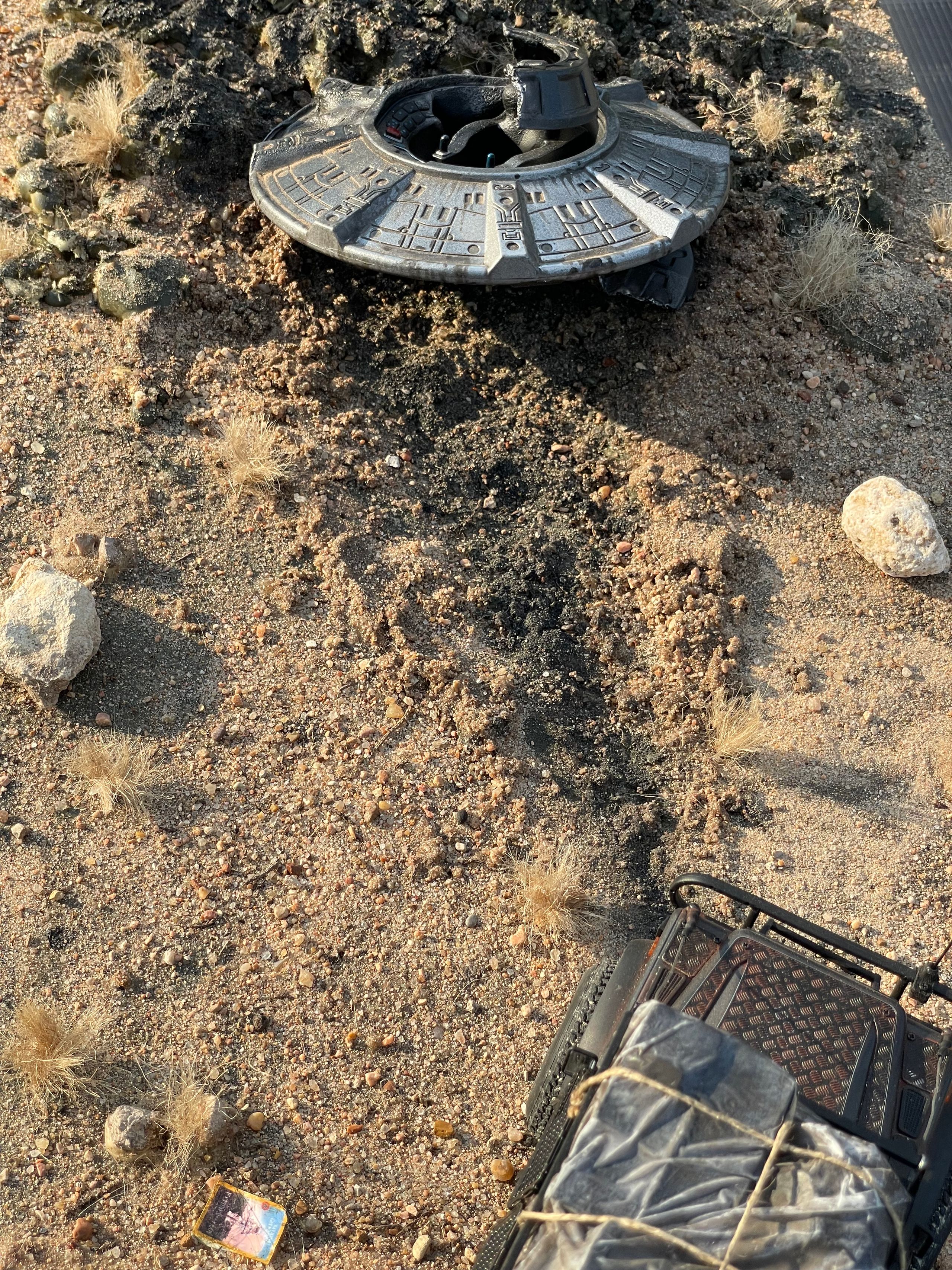1/24 scale diorama with UFO depicting the Roswell Incident, with desert landscape made from found materials, real dirt and rocks, modeling supplies, with 1/24 scale rugged overlanding Land Rover Defender 110.