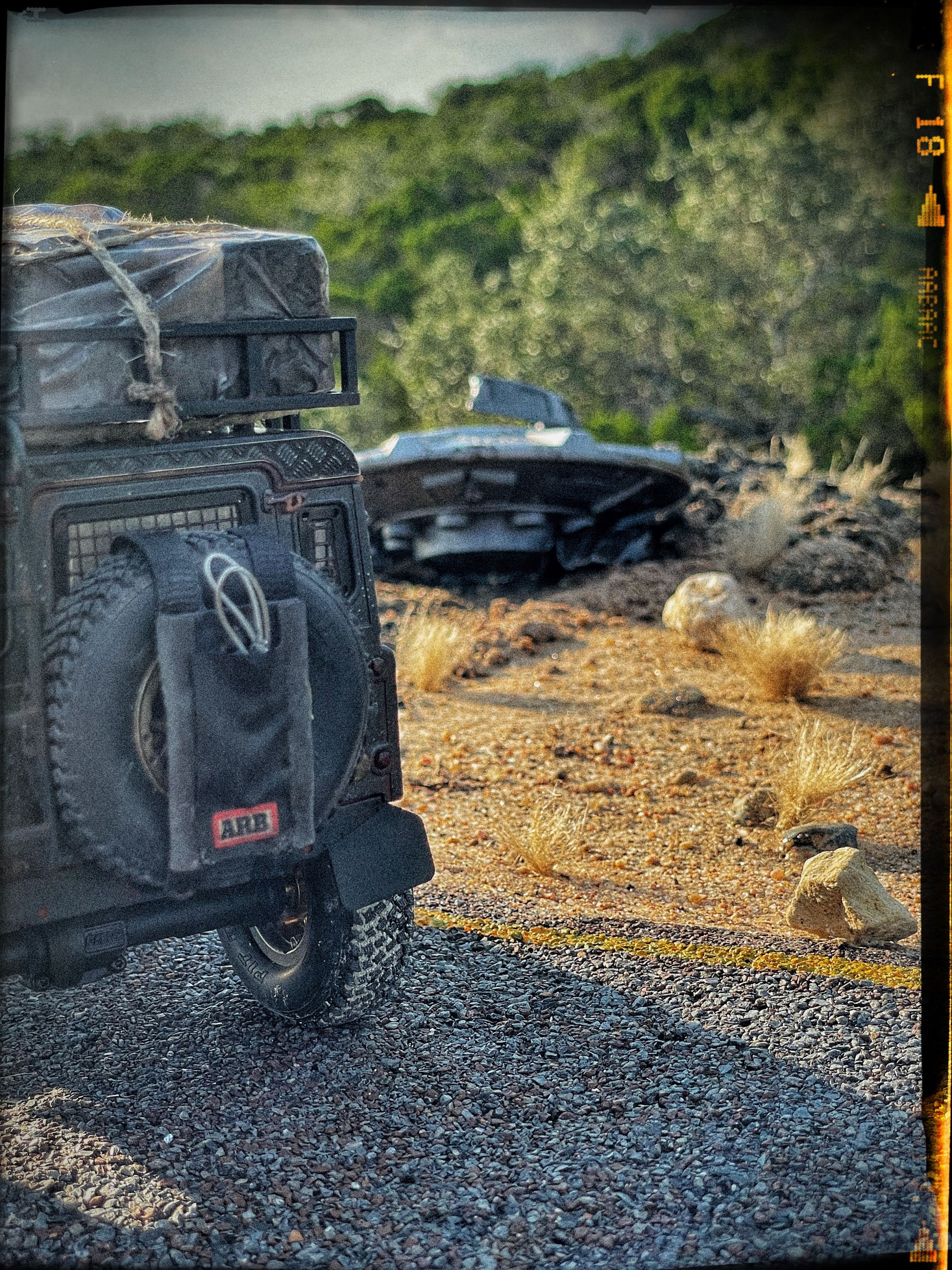 1/24 scale diorama with UFO depicting the Roswell Incident, with desert landscape made from found materials, real dirt and rocks, modeling supplies, with 1/24 scale rugged overlanding Land Rover Defender 110.