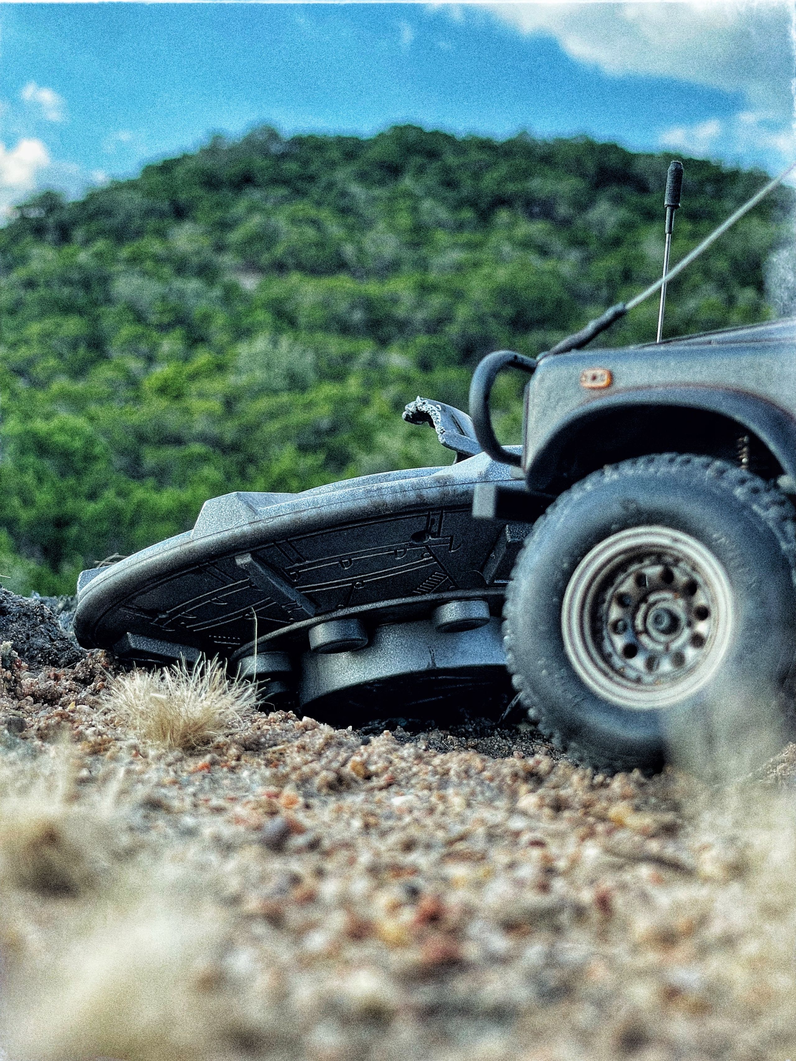 1/24 scale diorama with UFO depicting the Roswell Incident, with desert landscape made from found materials, real dirt and rocks, modeling supplies, with 1/24 scale rugged overlanding Land Rover Defender 110.