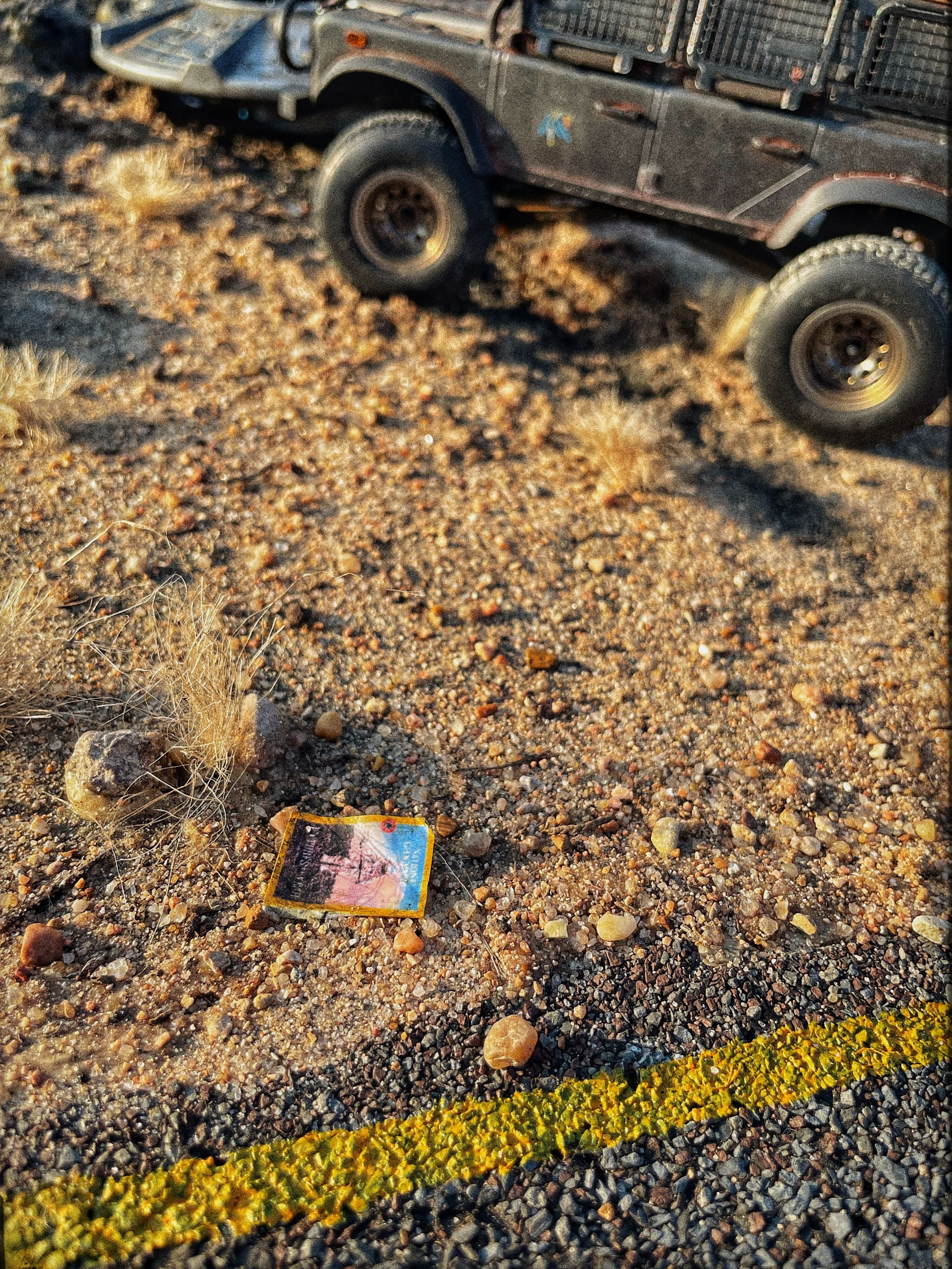 1/24 scale diorama with UFO depicting the Roswell Incident, with desert landscape made from found materials, real dirt and rocks, modeling supplies, with 1/24 scale rugged overlanding Land Rover Defender 110.