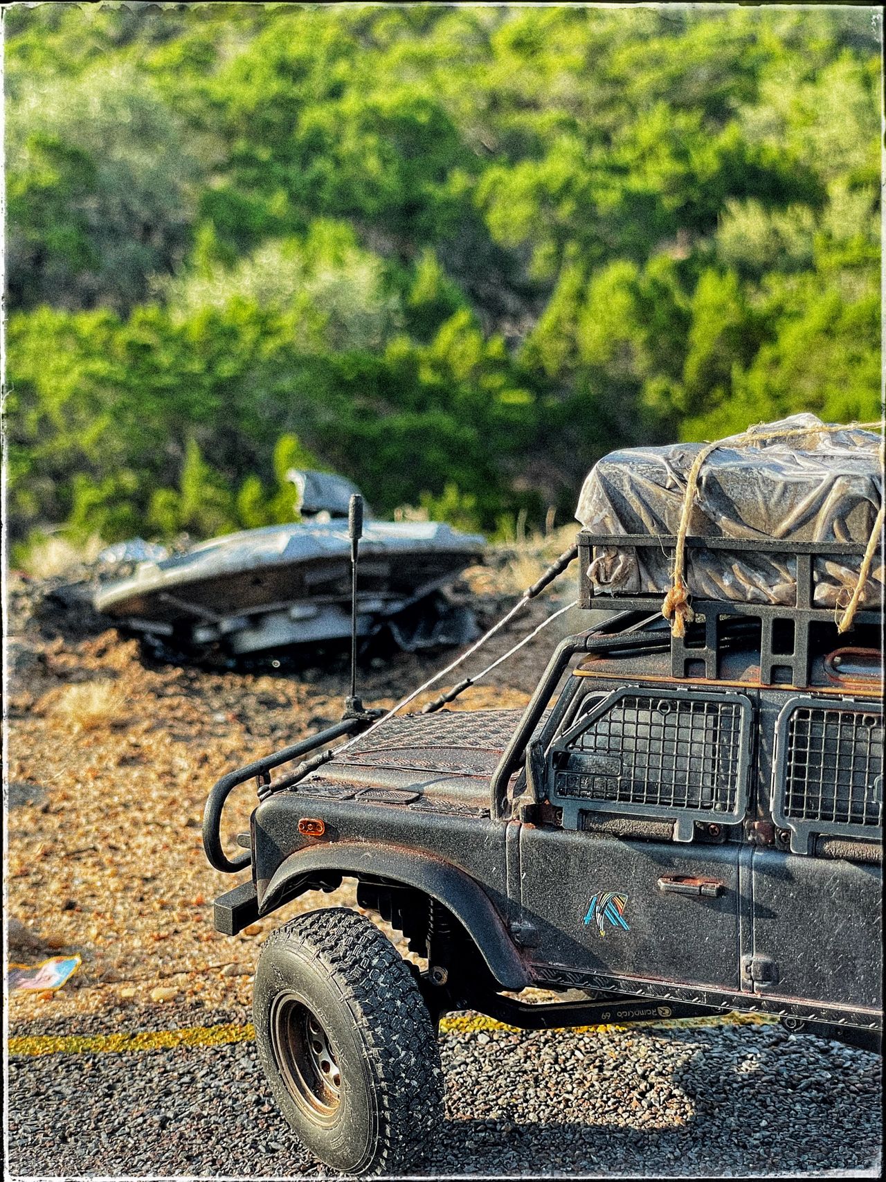 1/24 scale diorama with UFO depicting the Roswell Incident, with desert landscape made from found materials, real dirt and rocks, modeling supplies, with 1/24 scale rugged overlanding Land Rover Defender 110.
