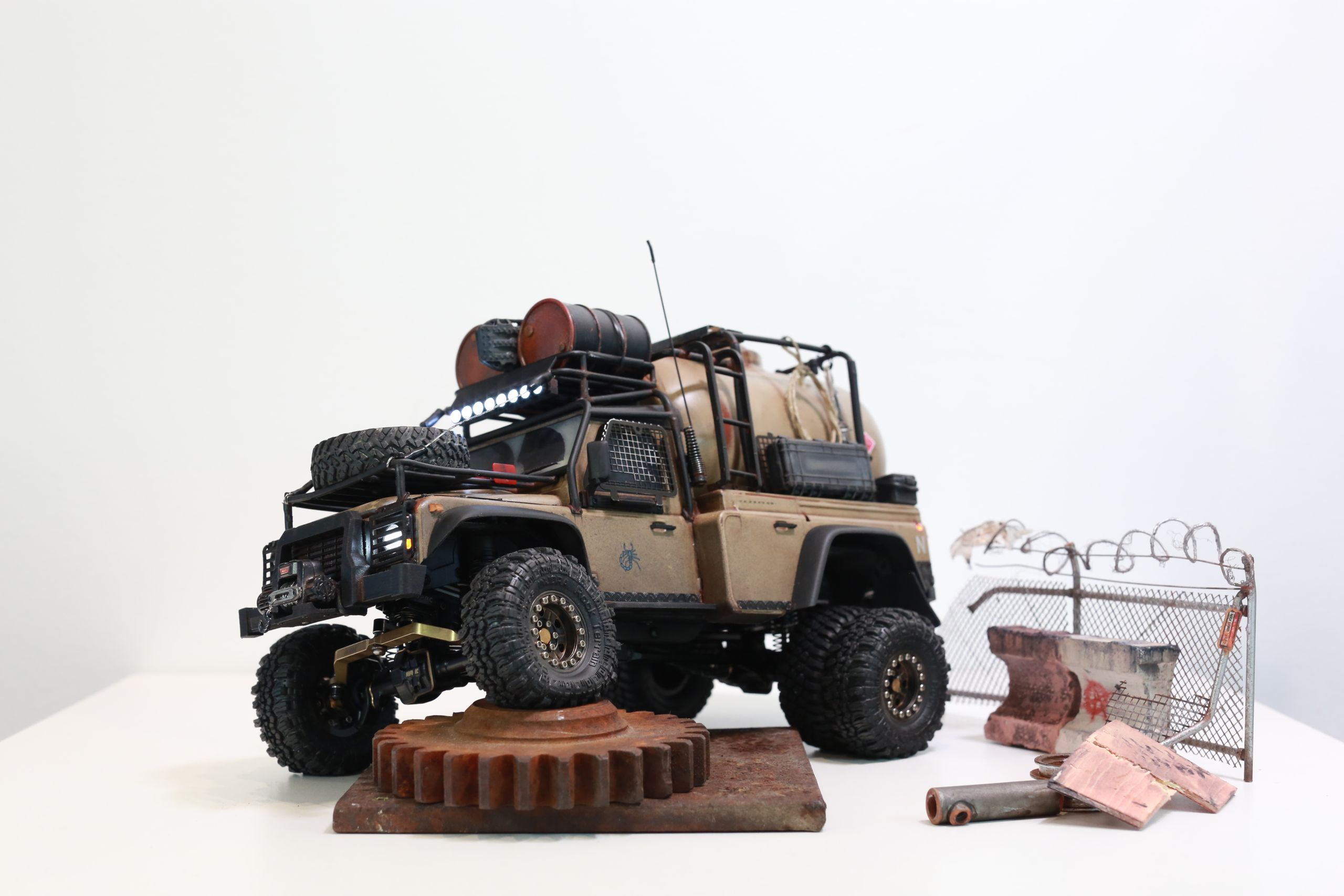The Land Rover Defender Resource Recovery Vehicle (RRV) is an imagined 1/18 scale post-apocalyptic tanker truck that roams the industrial wasteland harvesting fuel from abandoned sites for transport back to the survivor encampment.