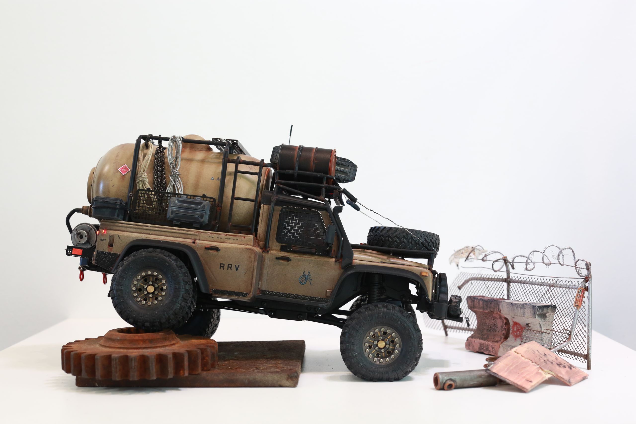 The Land Rover Defender Resource Recovery Vehicle (RRV) is an imagined 1/18 scale post-apocalyptic tanker truck that roams the industrial wasteland harvesting fuel from abandoned sites for transport back to the survivor encampment.