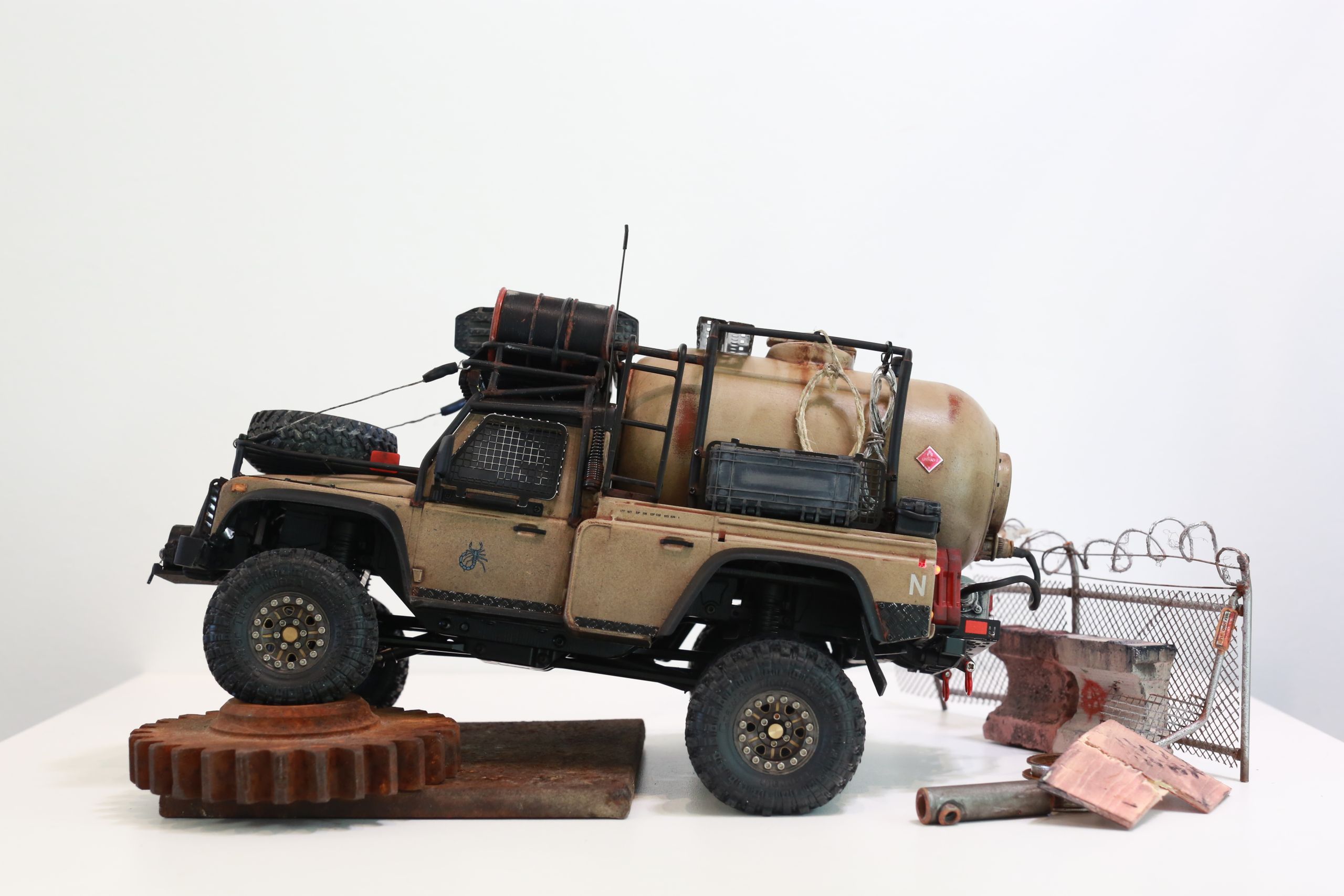 The Land Rover Defender Resource Recovery Vehicle (RRV) is an imagined 1/18 scale post-apocalyptic tanker truck that roams the industrial wasteland harvesting fuel from abandoned sites for transport back to the survivor encampment.