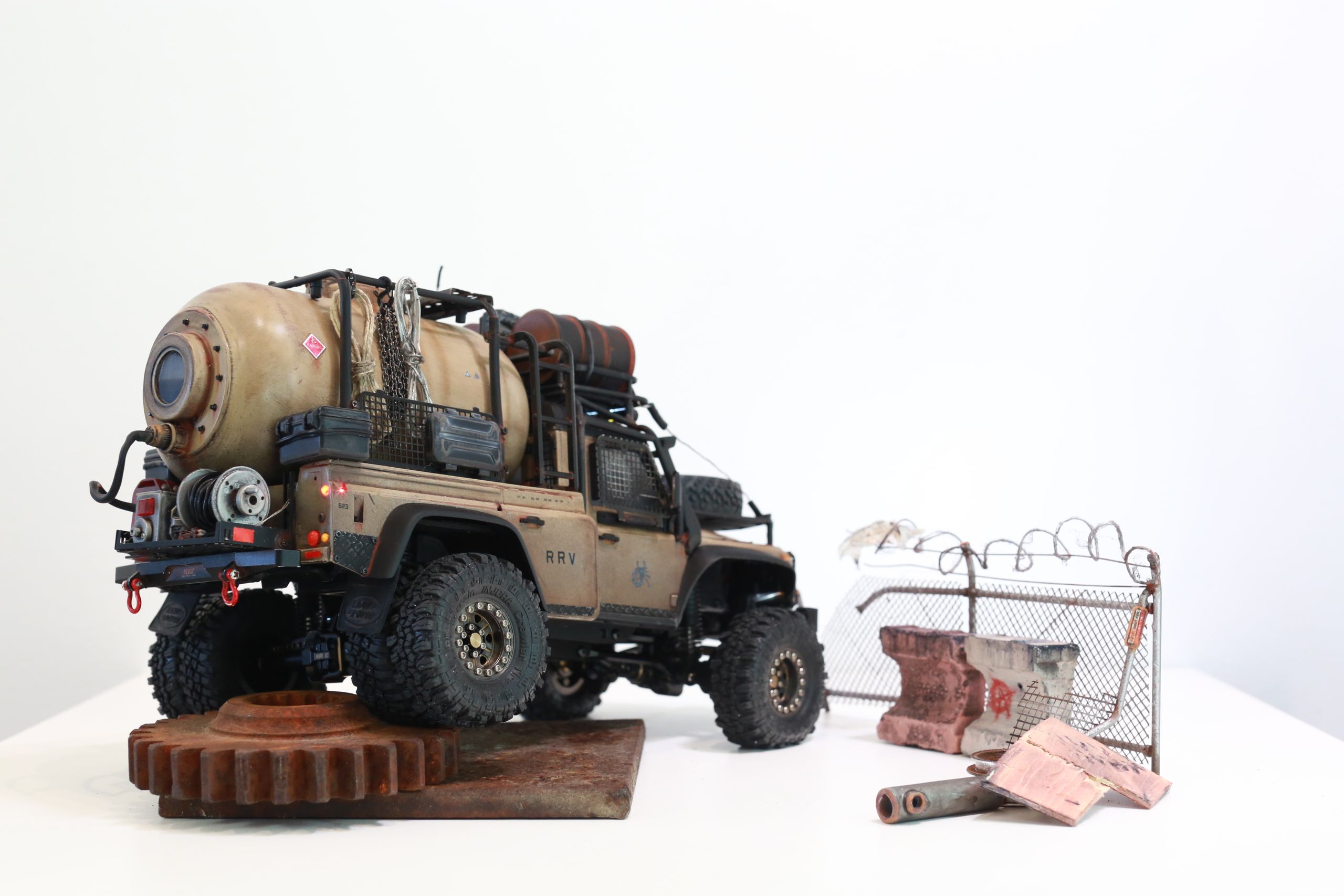 The Land Rover Defender Resource Recovery Vehicle (RRV) is an imagined 1/18 scale post-apocalyptic tanker truck that roams the industrial wasteland harvesting fuel from abandoned sites for transport back to the survivor encampment.