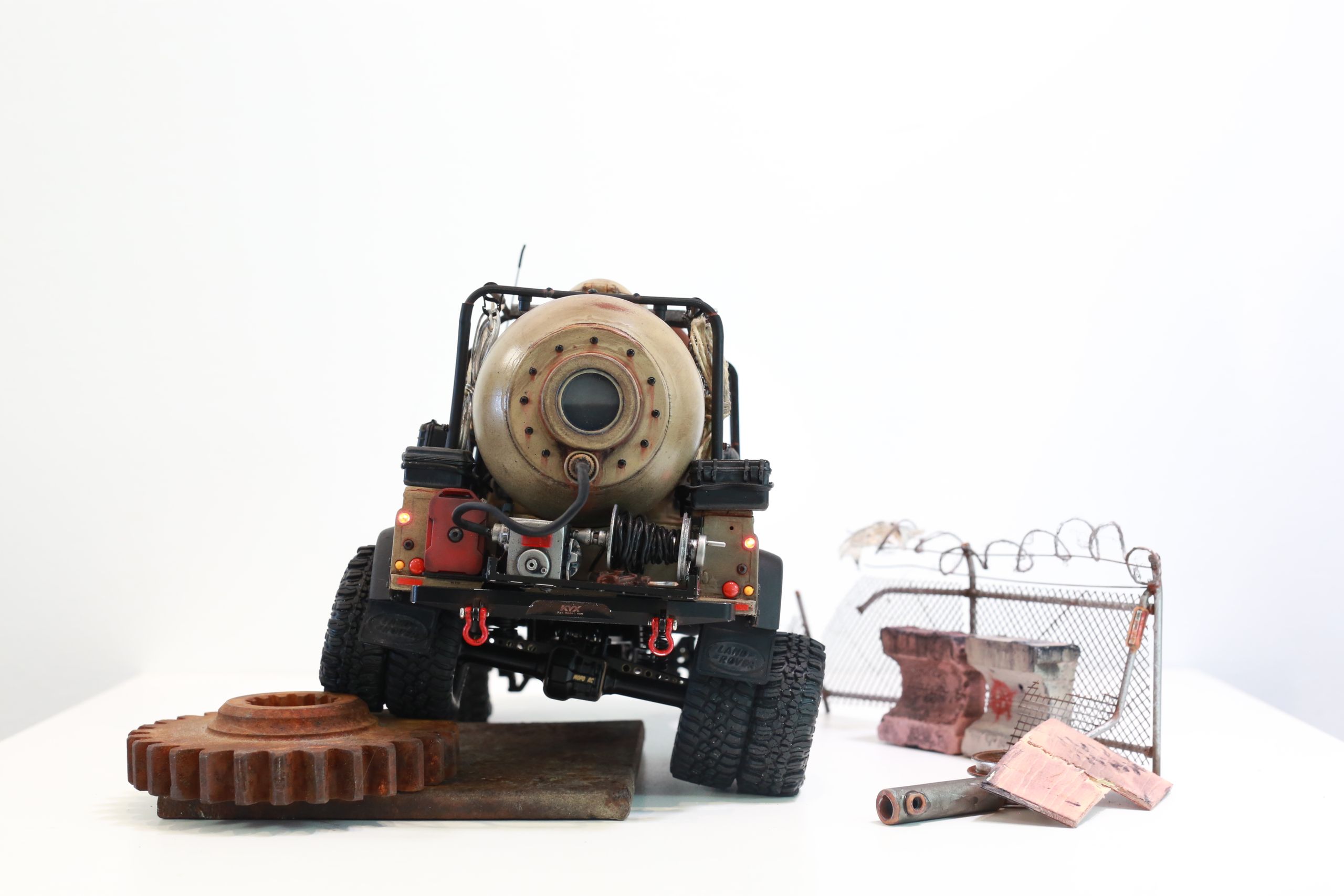 The Land Rover Defender Resource Recovery Vehicle (RRV) is an imagined 1/18 scale post-apocalyptic tanker truck that roams the industrial wasteland harvesting fuel from abandoned sites for transport back to the survivor encampment.