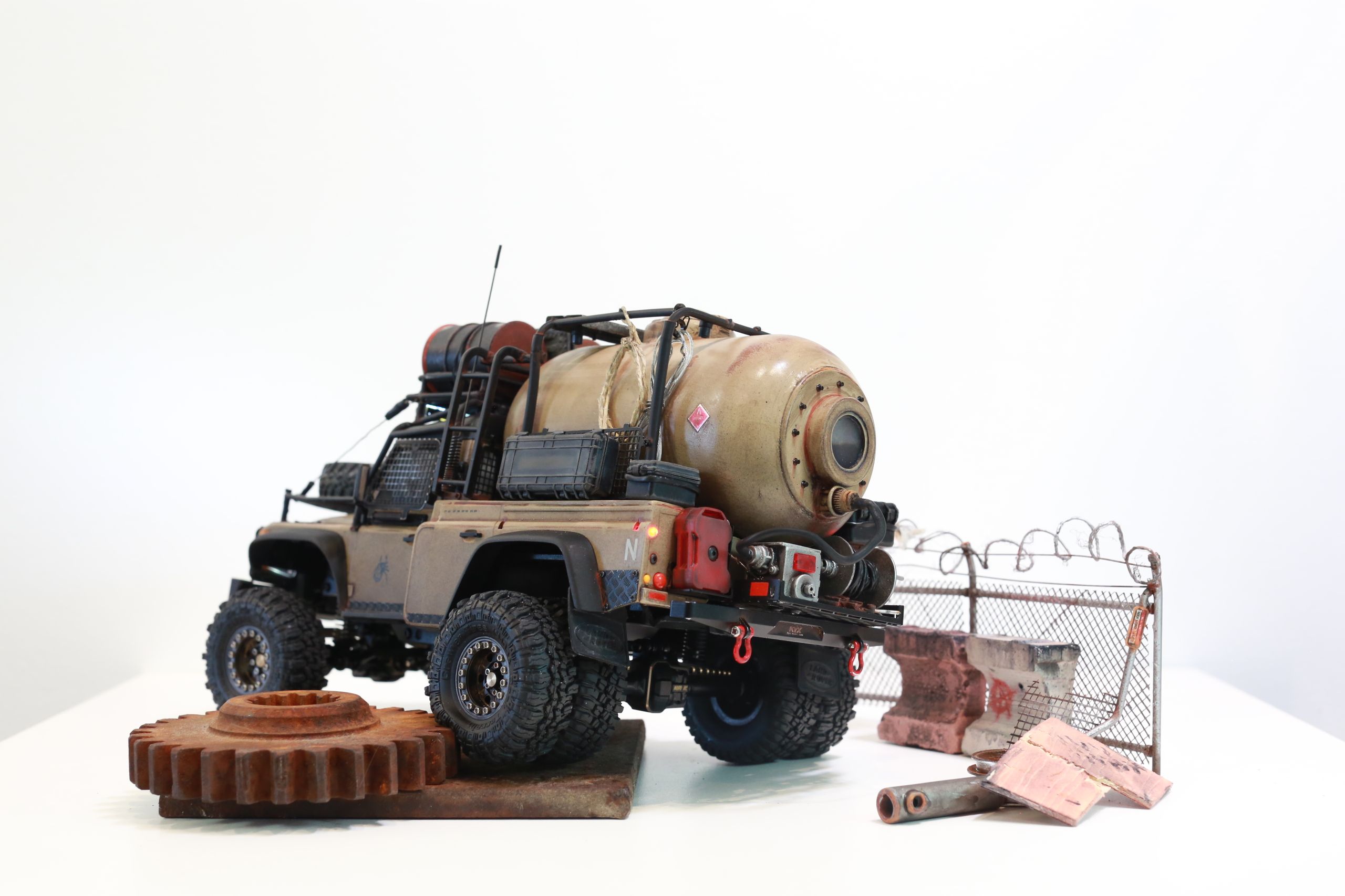 The Land Rover Defender Resource Recovery Vehicle (RRV) is an imagined 1/18 scale post-apocalyptic tanker truck that roams the industrial wasteland harvesting fuel from abandoned sites for transport back to the survivor encampment.
