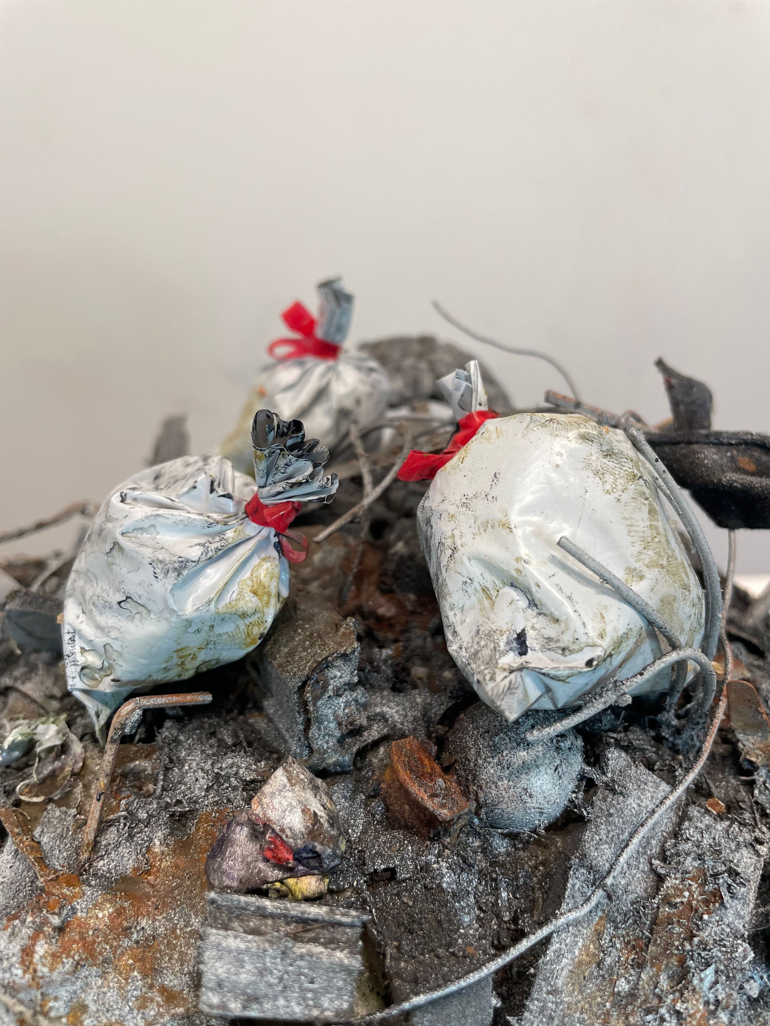 Sculpture made from Plastic, wood, foam, metal, wire, fabric, paint, paper, rubber, cardboard, CA glue, dirt, found objects with commentary on unsustainable economic, urban, and population growth on a finite planet, with a green stock market ticker rising above the wasteland symbolizing the piece's title, a popular stock market and cryptocurrency slogan