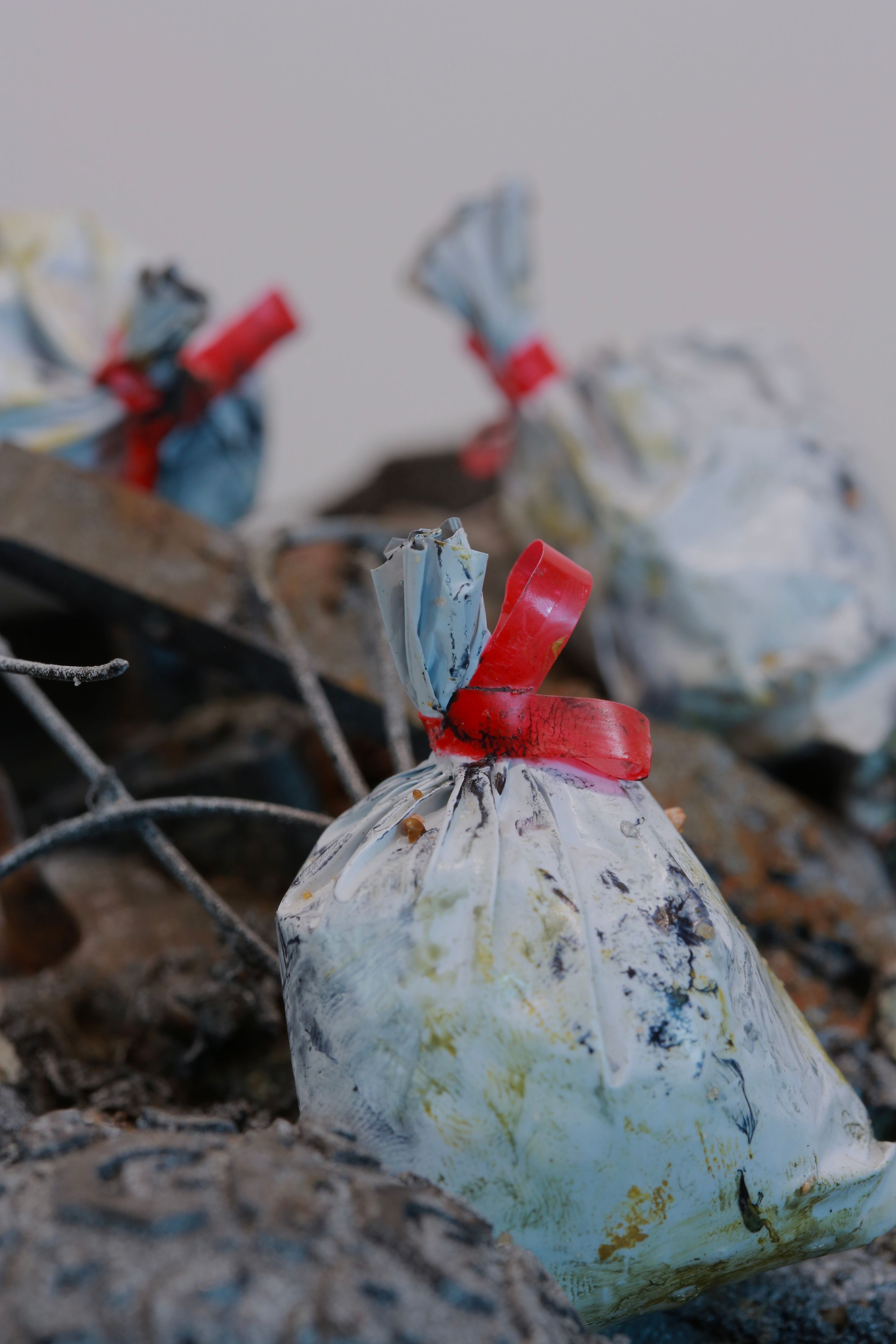 Sculpture made from Plastic, wood, foam, metal, wire, fabric, paint, paper, rubber, cardboard, CA glue, dirt, found objects with commentary on unsustainable economic, urban, and population growth on a finite planet, with a green stock market ticker rising above the wasteland symbolizing the piece's title, a popular stock market and cryptocurrency slogan