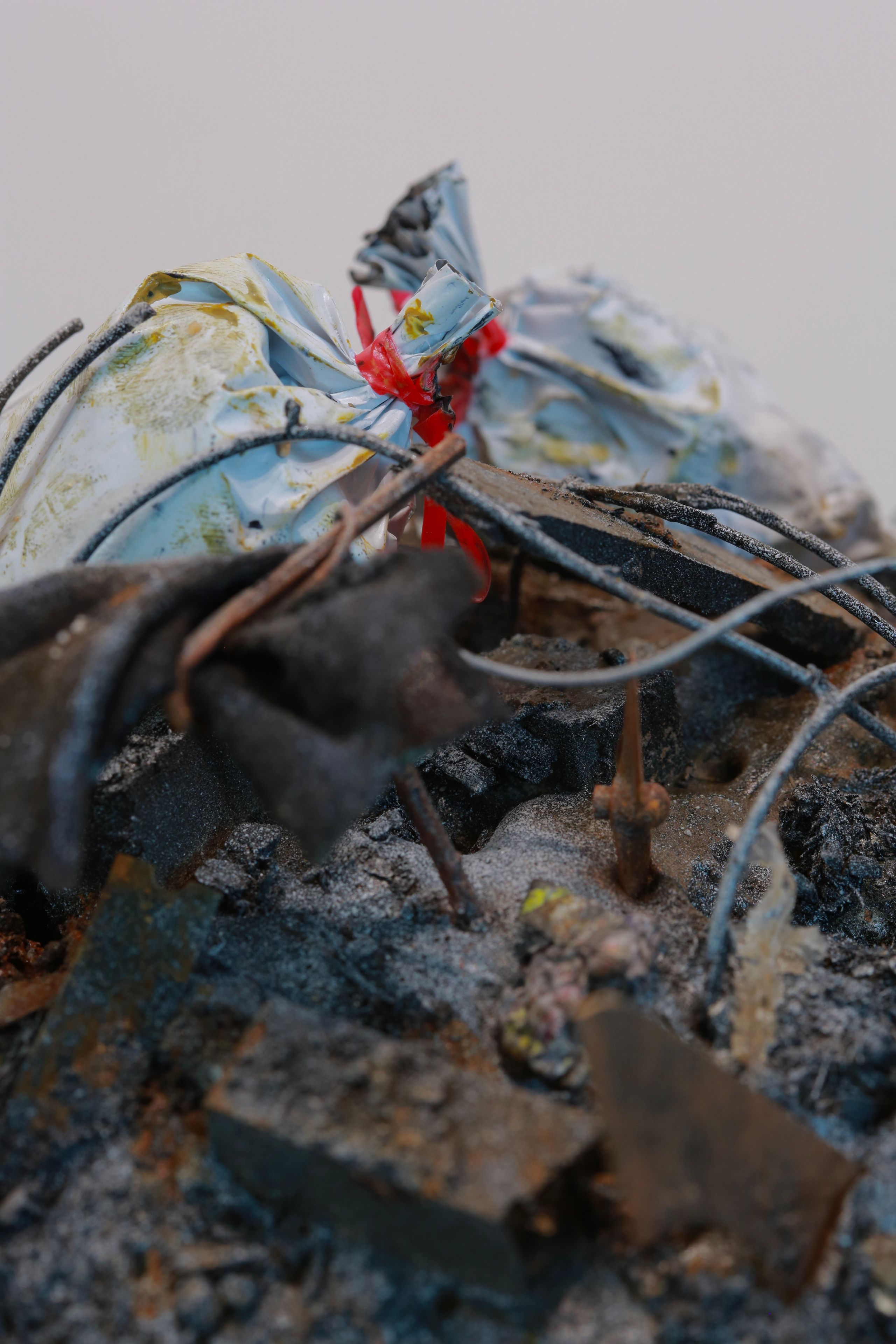 Sculpture made from Plastic, wood, foam, metal, wire, fabric, paint, paper, rubber, cardboard, CA glue, dirt, found objects with commentary on unsustainable economic, urban, and population growth on a finite planet, with a green stock market ticker rising above the wasteland symbolizing the piece's title, a popular stock market and cryptocurrency slogan