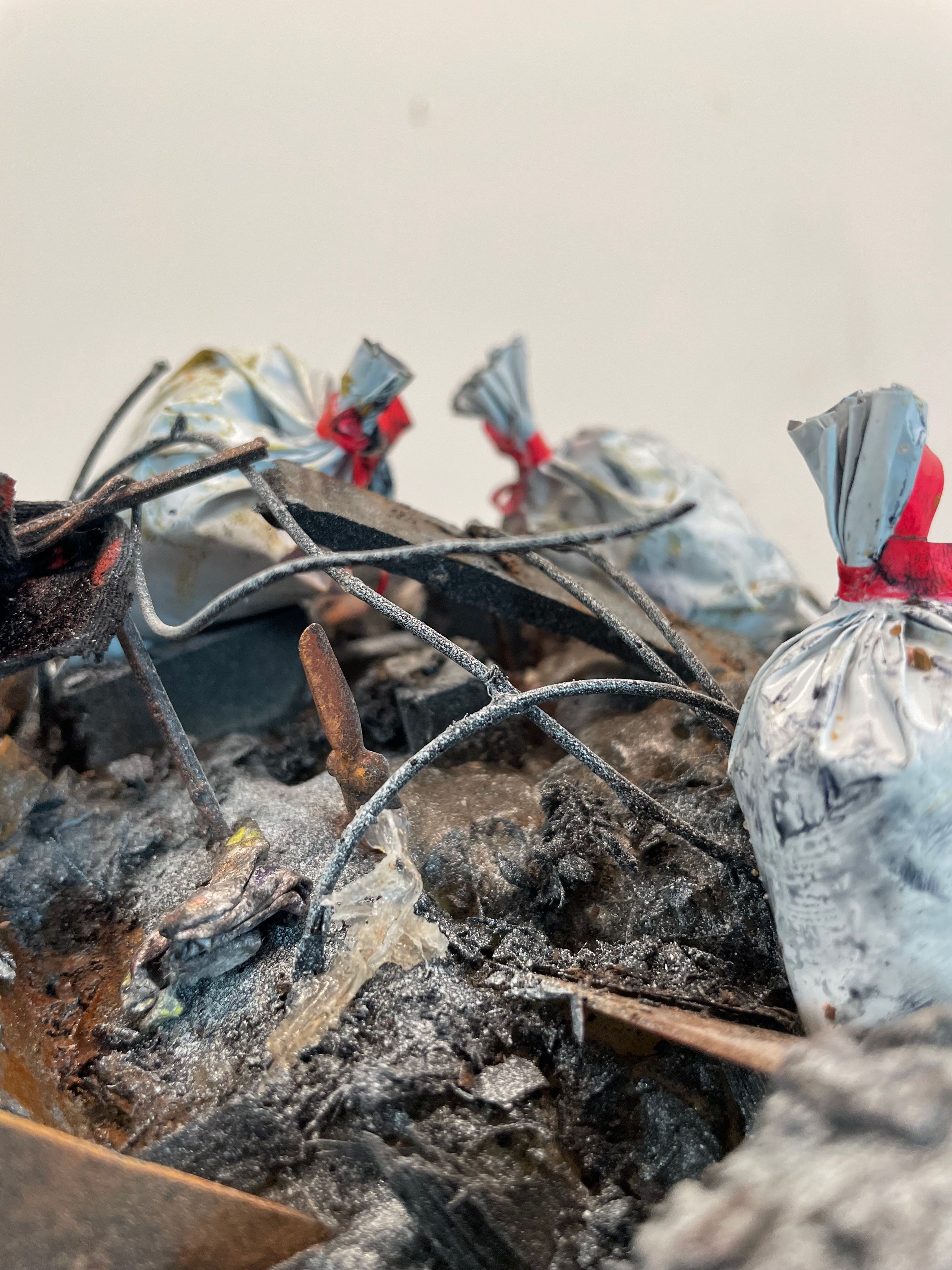 Sculpture made from Plastic, wood, foam, metal, wire, fabric, paint, paper, rubber, cardboard, CA glue, dirt, found objects with commentary on unsustainable economic, urban, and population growth on a finite planet, with a green stock market ticker rising above the wasteland symbolizing the piece's title, a popular stock market and cryptocurrency slogan