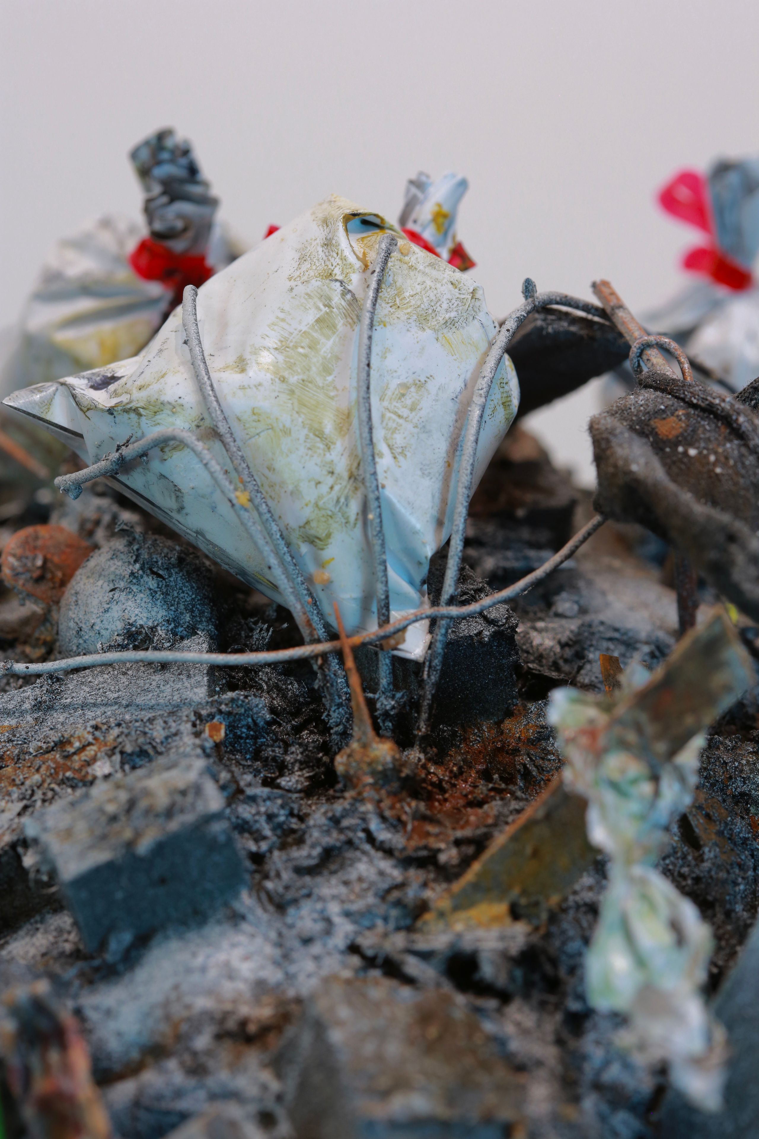 Sculpture made from Plastic, wood, foam, metal, wire, fabric, paint, paper, rubber, cardboard, CA glue, dirt, found objects with commentary on unsustainable economic, urban, and population growth on a finite planet, with a green stock market ticker rising above the wasteland symbolizing the piece's title, a popular stock market and cryptocurrency slogan
