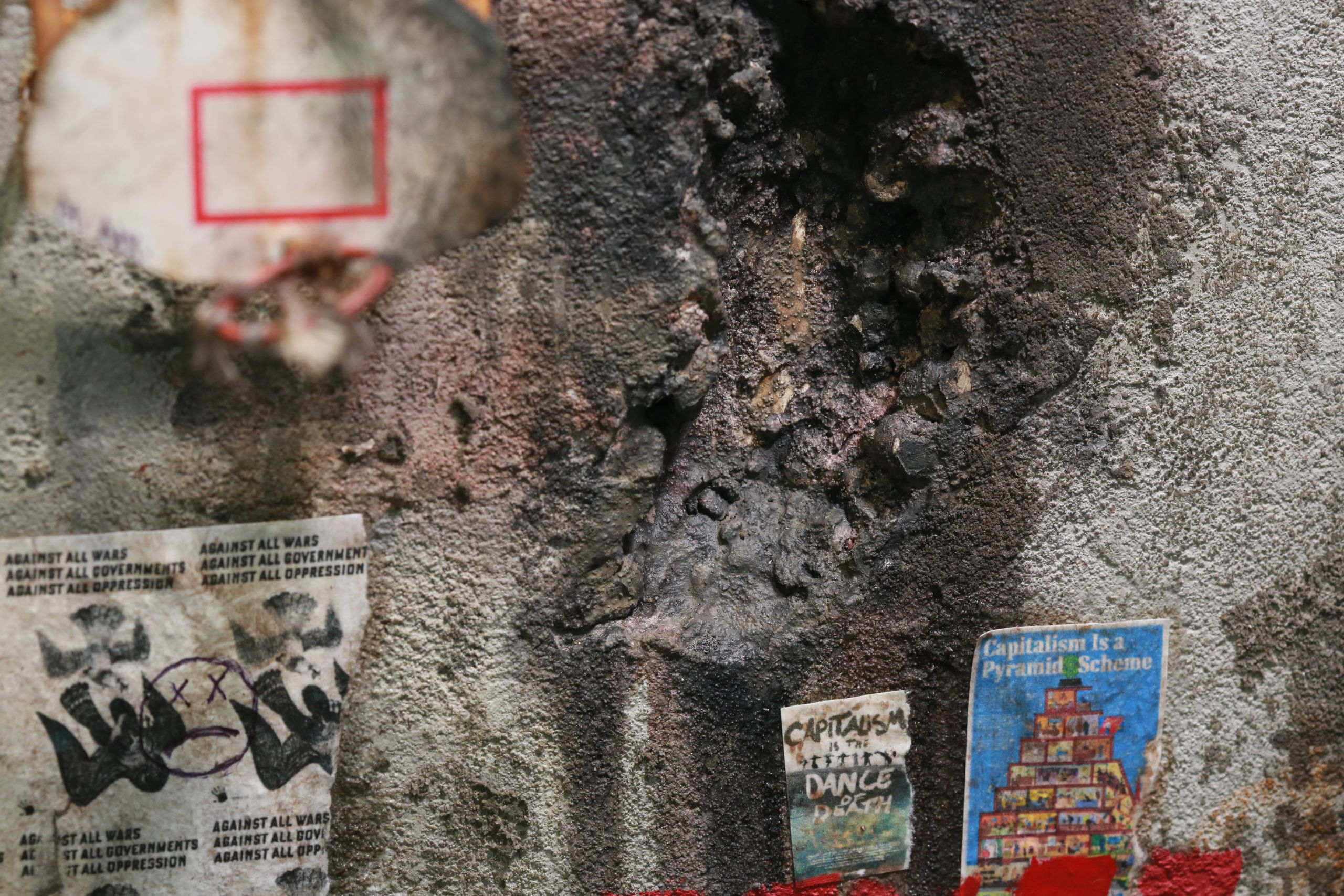 1/24-1/18 scale miniature diorama of a bombed out post apocalyptic inner city street alley way, with corrugated steel auto garage bay door, graffiti mural, and Frank Lloyd Wright Ennis House tiles