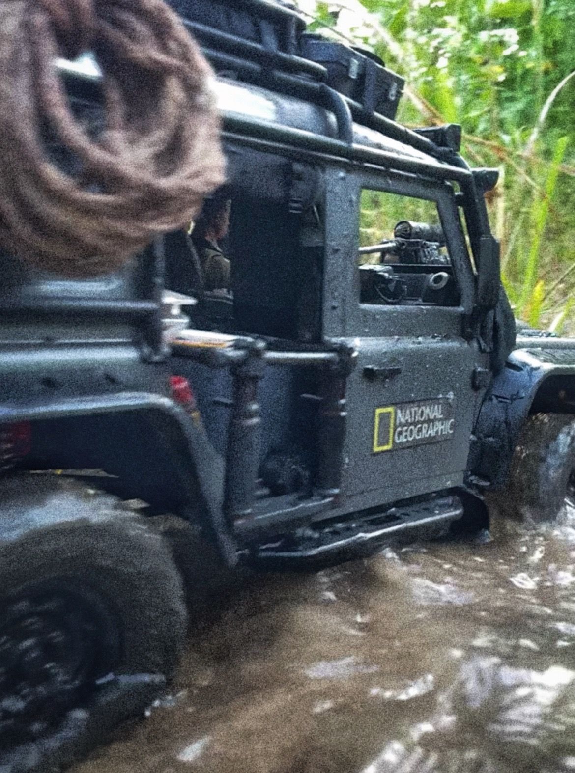 1/10 scale RC Defender 110 build inspired by the heavily modified and customized Land Rover Defenders used by National Geographic photographers in the 80s and 90s in places like the African savanna, featuring a custom cab interior and rear camera platforms, as well as many handmade accessories constructed from found objects and household junk.