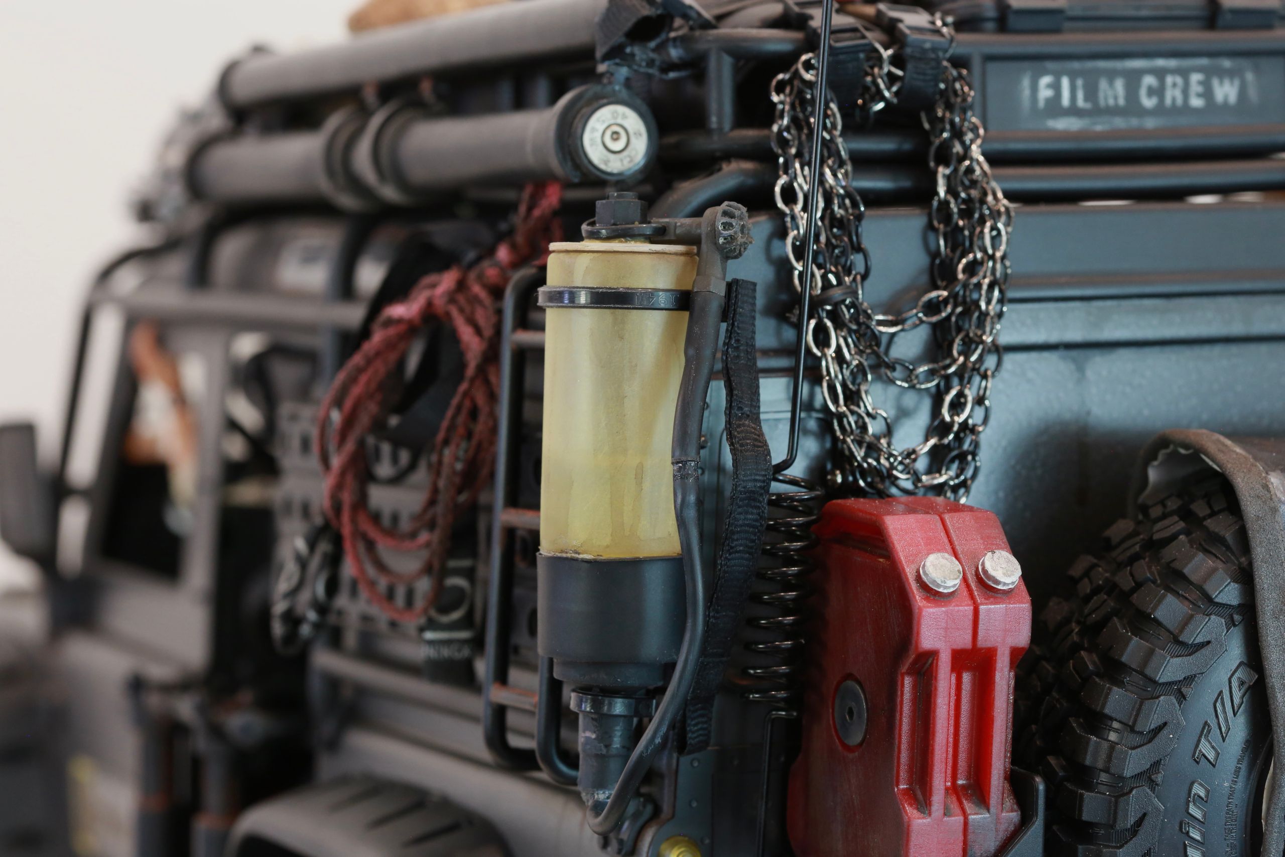 1/10 scale RC Defender 110 build inspired by the heavily modified and customized Land Rover Defenders used by National Geographic photographers in the 80s and 90s in places like the African savanna, featuring a custom cab interior and rear camera platforms, as well as many handmade accessories constructed from found objects and household junk.