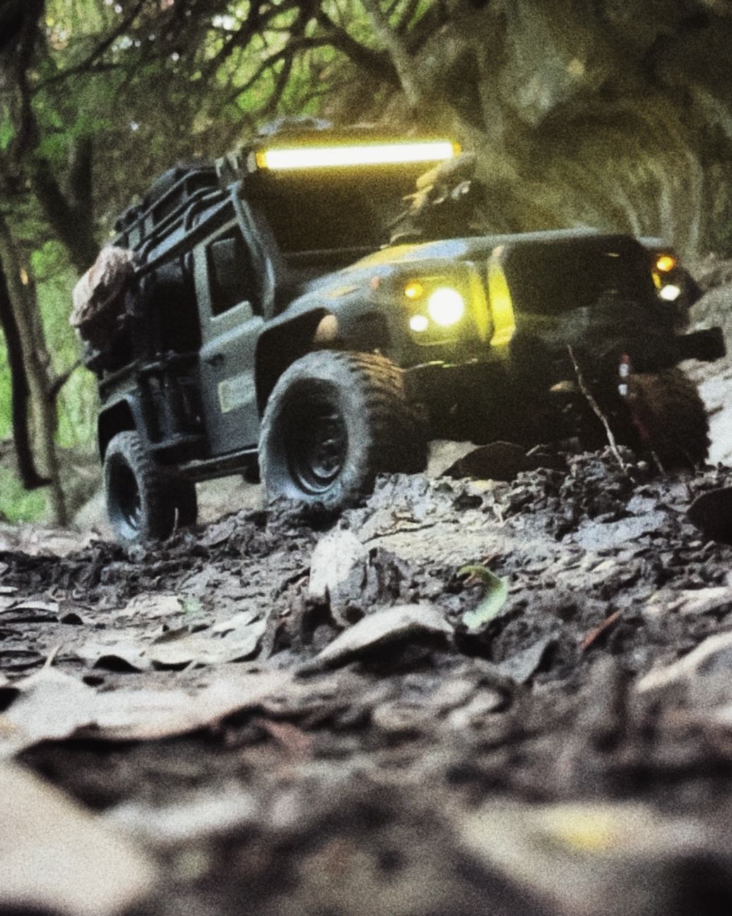 1/10 scale RC Defender 110 build inspired by the heavily modified and customized Land Rover Defenders used by National Geographic photographers in the 80s and 90s in places like the African savanna, featuring a custom cab interior and rear camera platforms, as well as many handmade accessories constructed from found objects and household junk.