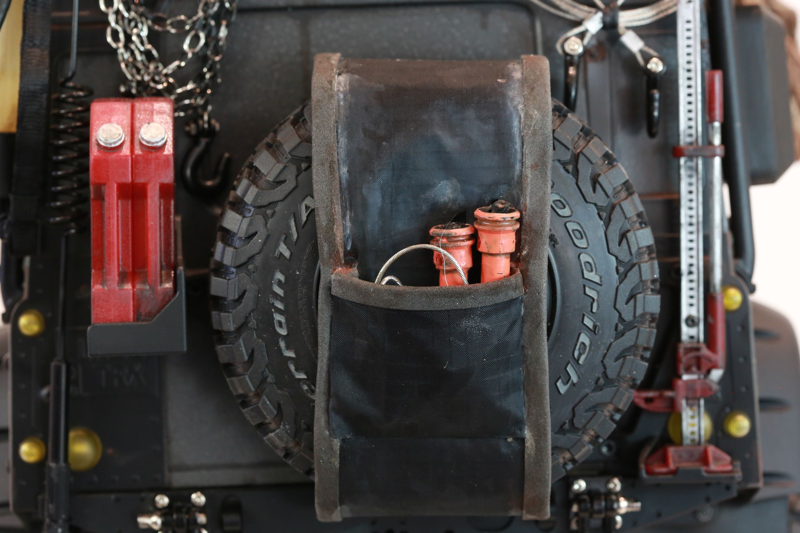 1/10 scale RC Defender 110 build inspired by the heavily modified and customized Land Rover Defenders used by National Geographic photographers in the 80s and 90s in places like the African savanna, featuring a custom cab interior and rear camera platforms, as well as many handmade accessories constructed from found objects and household junk.