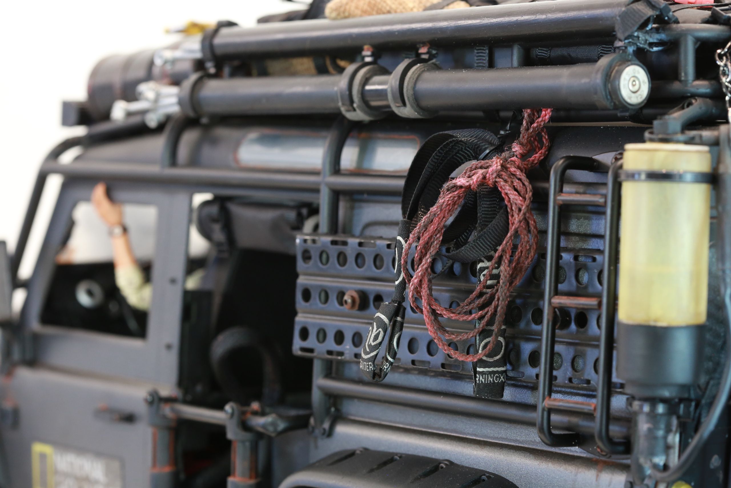 1/10 scale RC Defender 110 build inspired by the heavily modified and customized Land Rover Defenders used by National Geographic photographers in the 80s and 90s in places like the African savanna, featuring a custom cab interior and rear camera platforms, as well as many handmade accessories constructed from found objects and household junk.