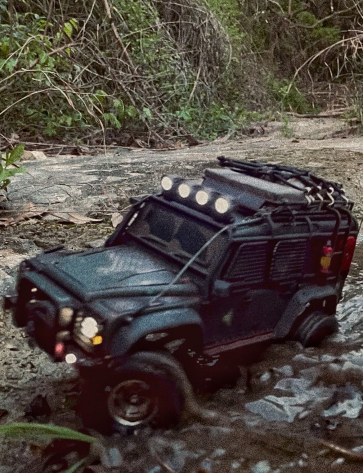 1/18 scale RC Land Rover Defender build inspired by post-apocalyptic franchises like "The Last Of Us" and "28 Days Later" featuring a working winch constructed from a retractable lanyard spool mounted underneath the hood.