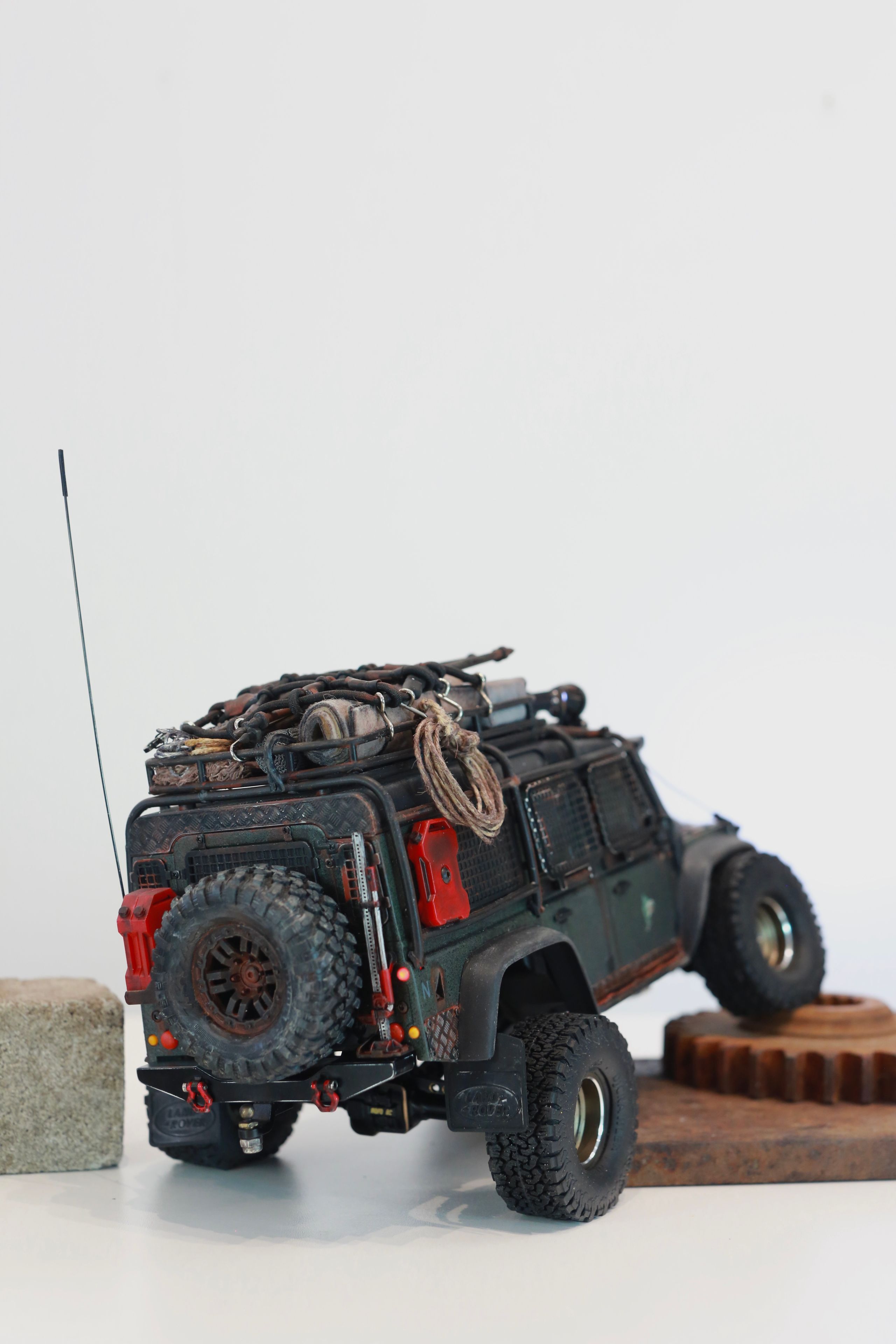 1/18 scale RC Land Rover Defender build inspired by post-apocalyptic franchises like "The Last Of Us" and "28 Days Later" featuring a working winch constructed from a retractable lanyard spool mounted underneath the hood.