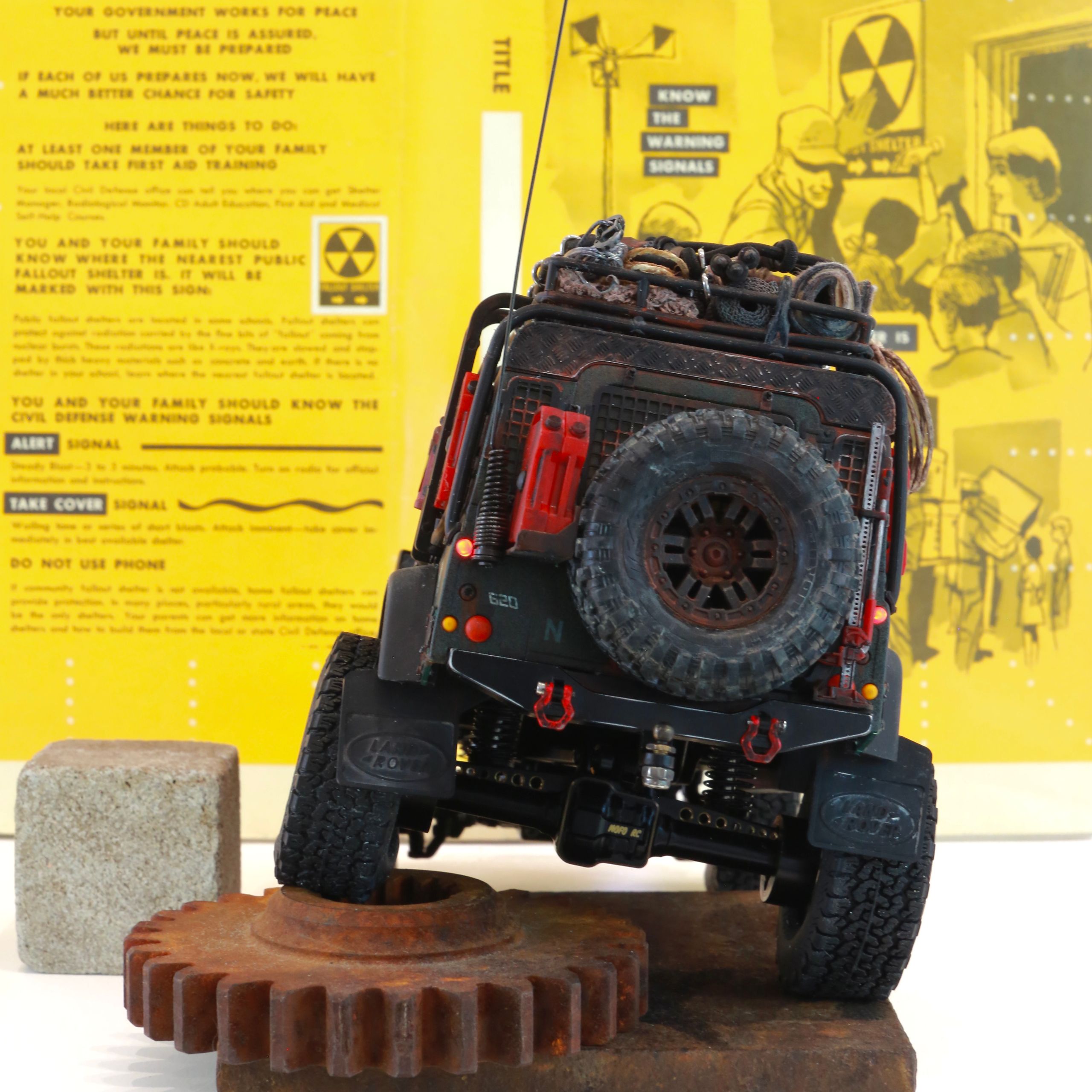 1/18 scale RC Land Rover Defender build inspired by post-apocalyptic franchises like "The Last Of Us" and "28 Days Later" featuring a working winch constructed from a retractable lanyard spool mounted underneath the hood.