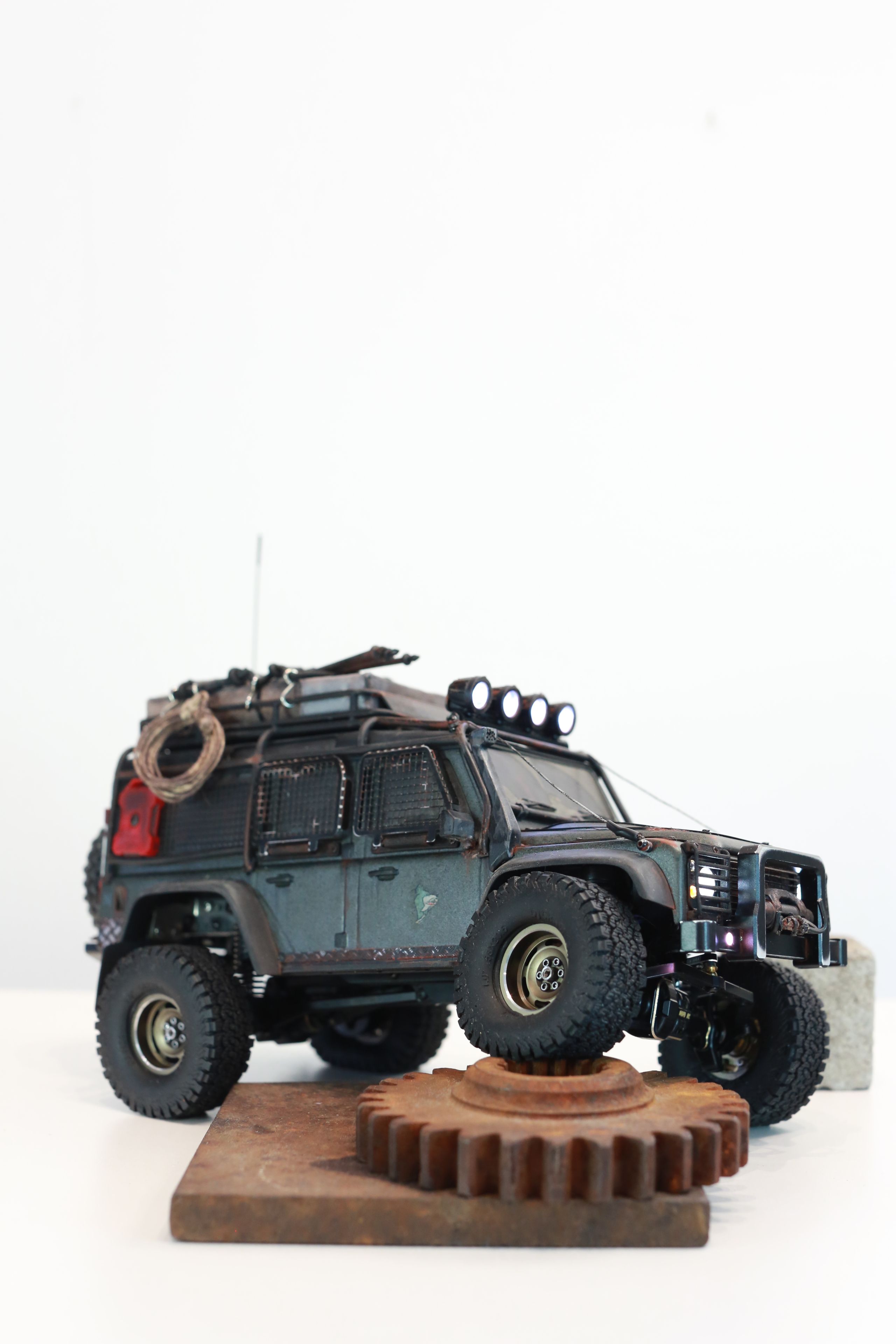 1/18 scale RC Land Rover Defender build inspired by post-apocalyptic franchises like "The Last Of Us" and "28 Days Later" featuring a working winch constructed from a retractable lanyard spool mounted underneath the hood.