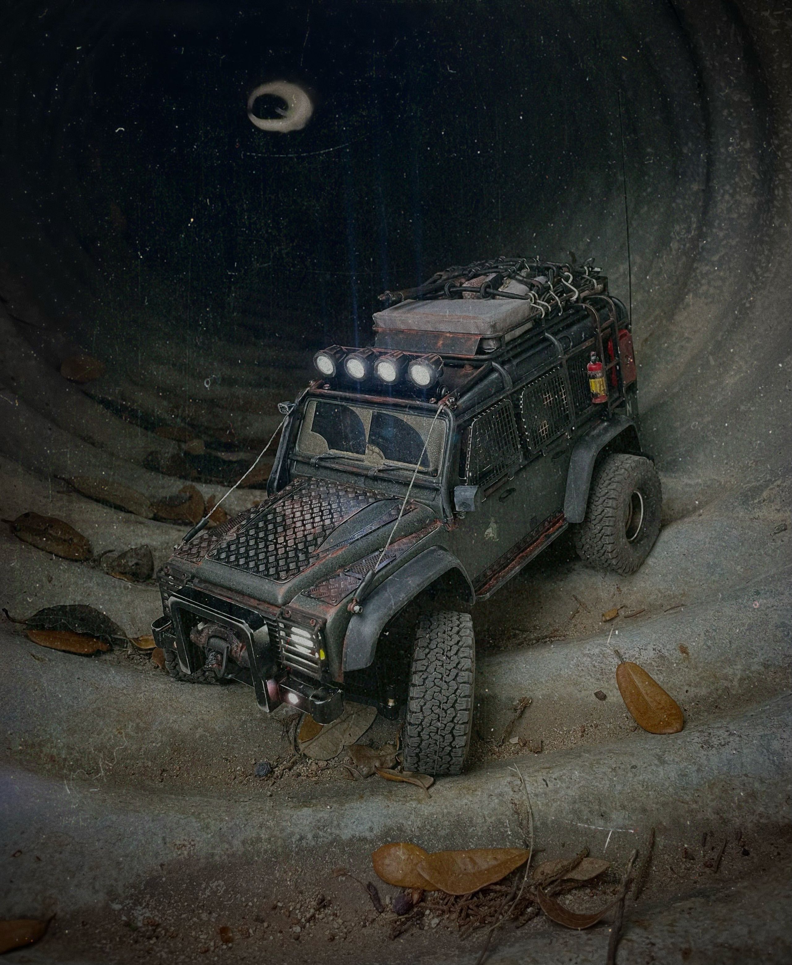 1/18 scale RC Land Rover Defender build inspired by post-apocalyptic franchises like "The Last Of Us" and "28 Days Later" featuring a working winch constructed from a retractable lanyard spool mounted underneath the hood.
