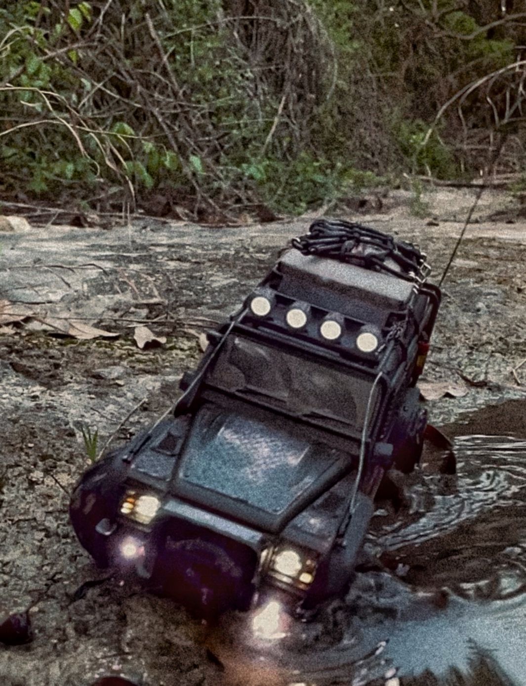 1/18 scale RC Land Rover Defender build inspired by post-apocalyptic franchises like "The Last Of Us" and "28 Days Later" featuring a working winch constructed from a retractable lanyard spool mounted underneath the hood.