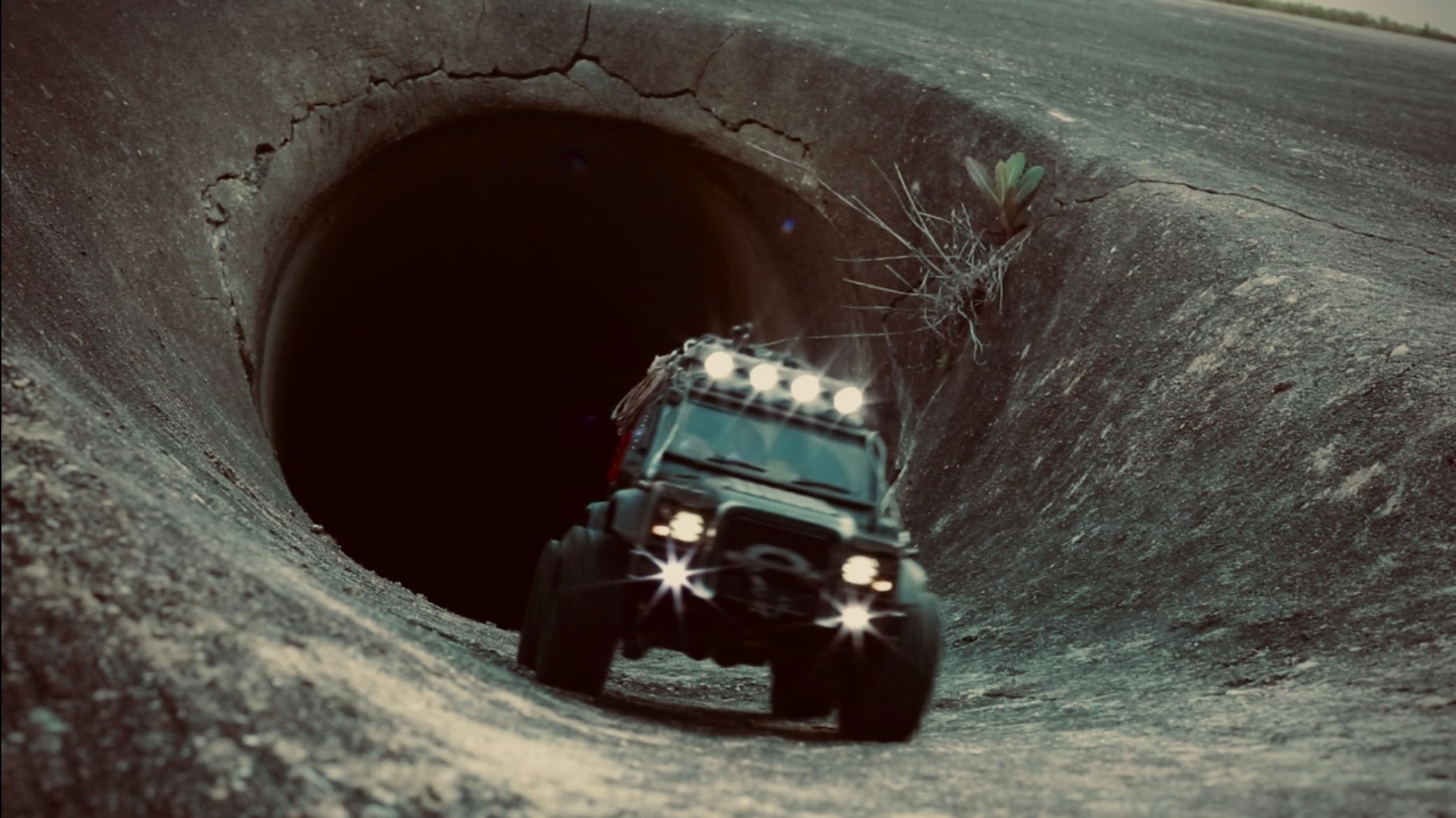 1/18 scale RC Land Rover Defender build inspired by post-apocalyptic franchises like "The Last Of Us" and "28 Days Later" featuring a working winch constructed from a retractable lanyard spool mounted underneath the hood.