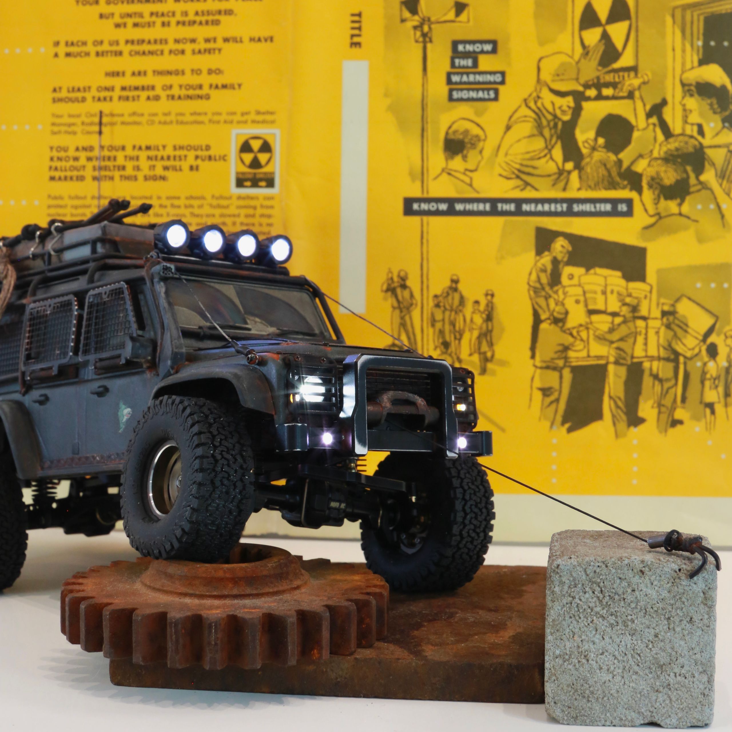 1/18 scale RC Land Rover Defender build inspired by post-apocalyptic franchises like "The Last Of Us" and "28 Days Later" featuring a working winch constructed from a retractable lanyard spool mounted underneath the hood.