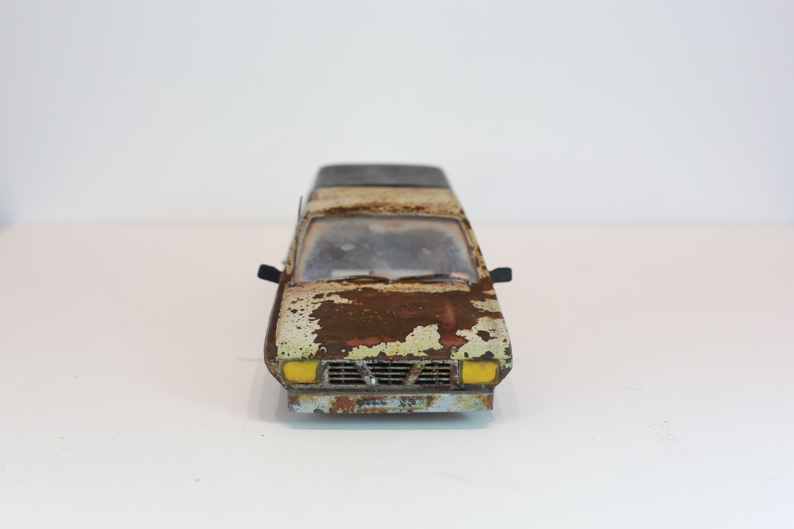 Old junkyard Nissan 1/24 scale 3d printed pickup body for scx24 RC truck with real rust patina, dents, duct tape windows, and custom bumpers.