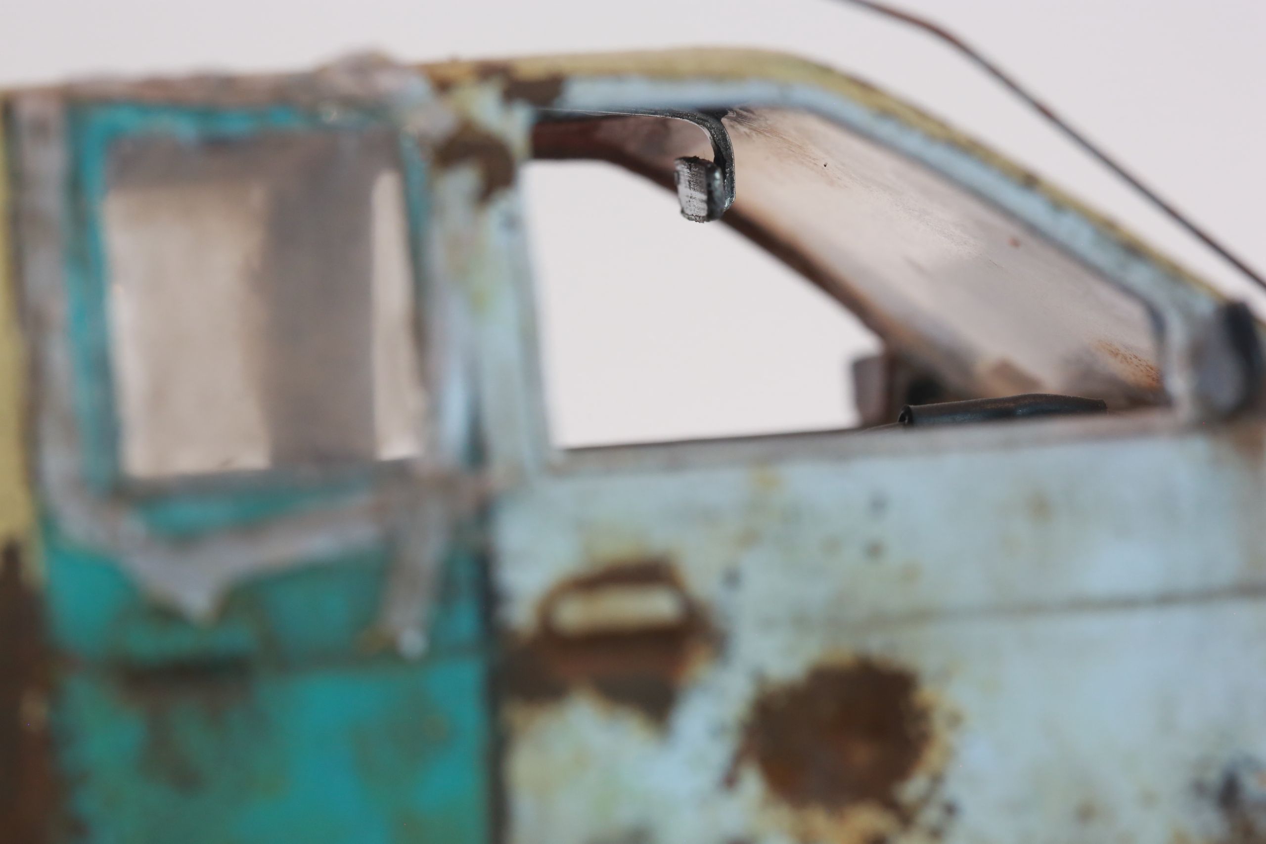 Old junkyard Nissan 1/24 scale 3d printed pickup body for scx24 RC truck with real rust patina, dents, duct tape windows, and custom bumpers.