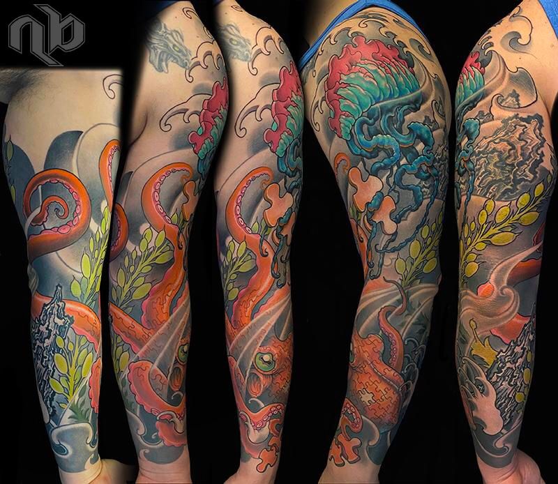 color arm tattoo of portuguese manowar jellyfish and orange octopus with puzzle piece shaped cutouts and pieces to symbolise autism awareness by nick baxter in austin texas