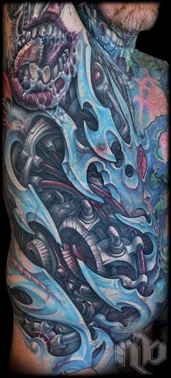 color biomechanical blades and machinery rib tattoo by nick baxter in austin texas