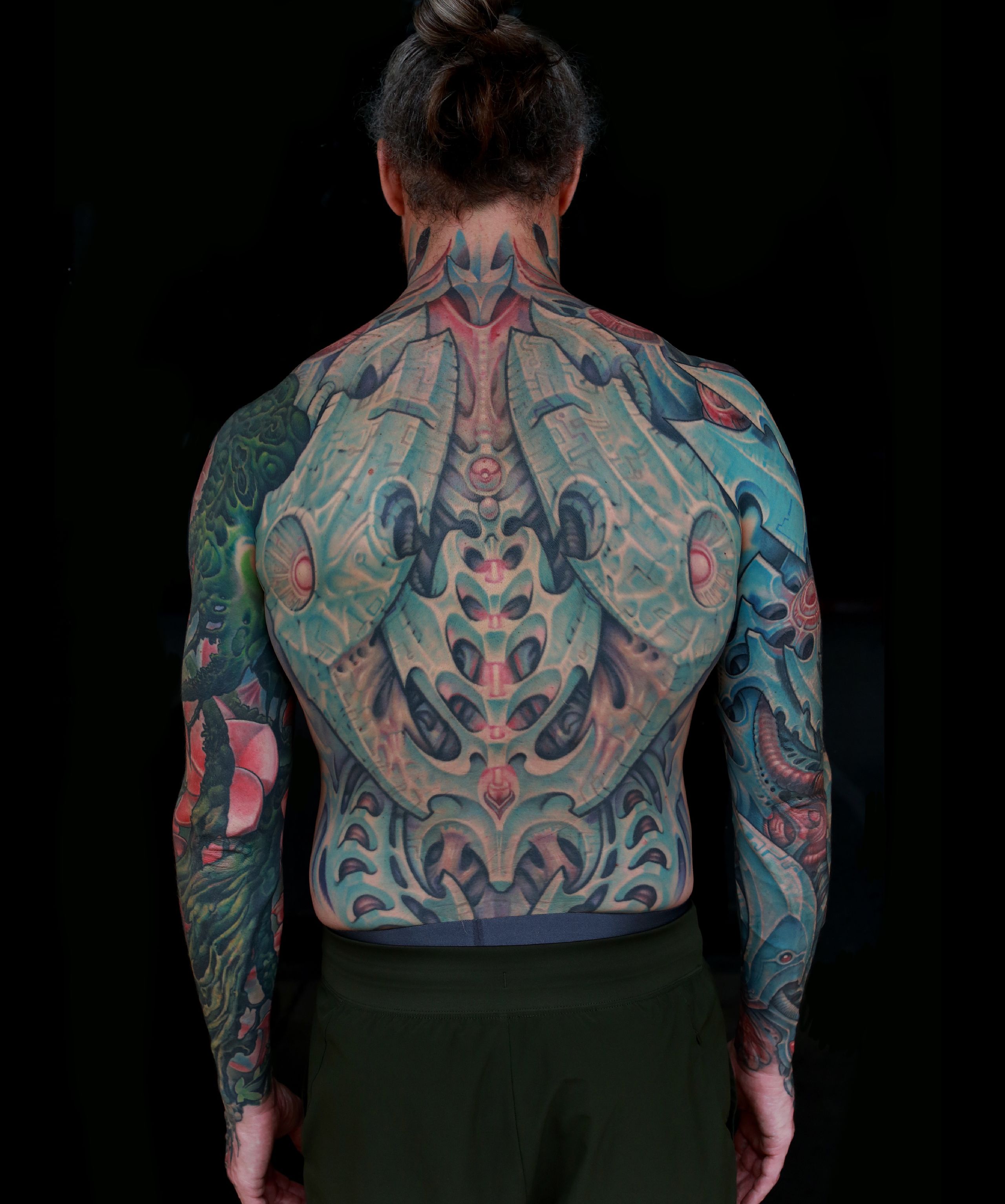 color biomechanical sleeve and back tattoo of blades and cables and robot machinery by nick baxter in austin texas