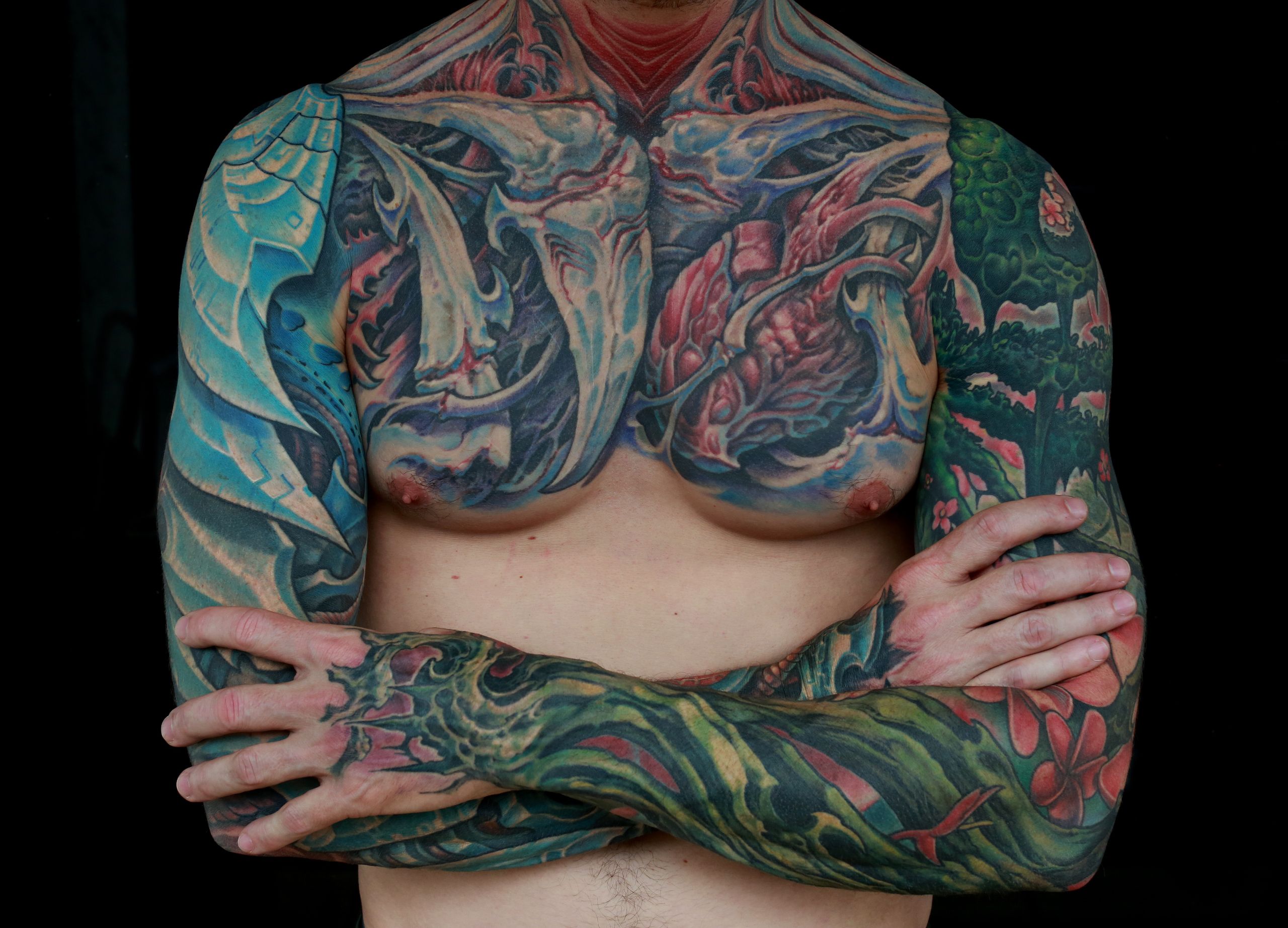 color biomechanical sleeve and back tattoo of blades and cables and robot machinery by nick baxter in austin texas
