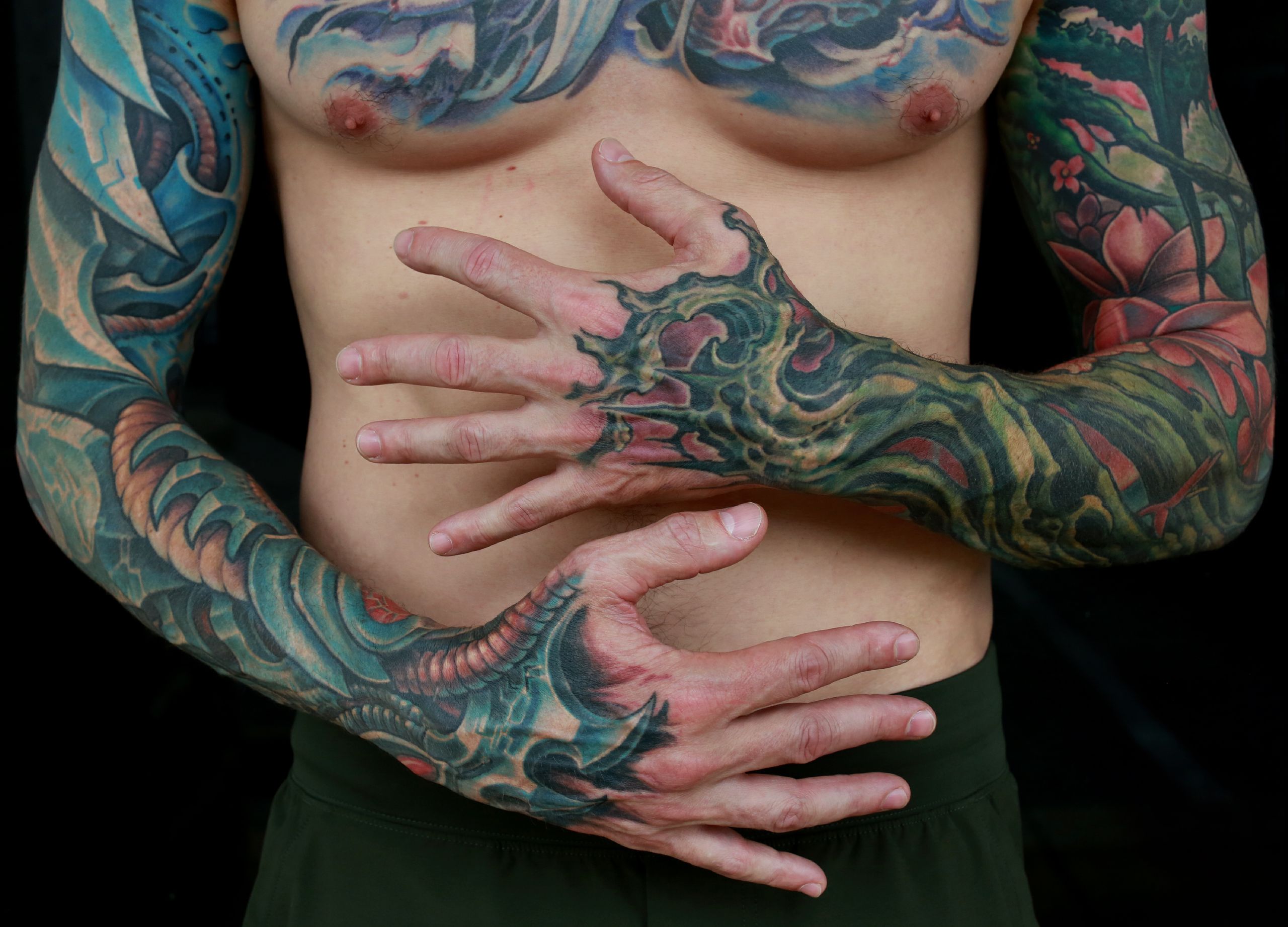color biomechanical sleeve and back tattoo of blades and cables and robot machinery by nick baxter in austin texas