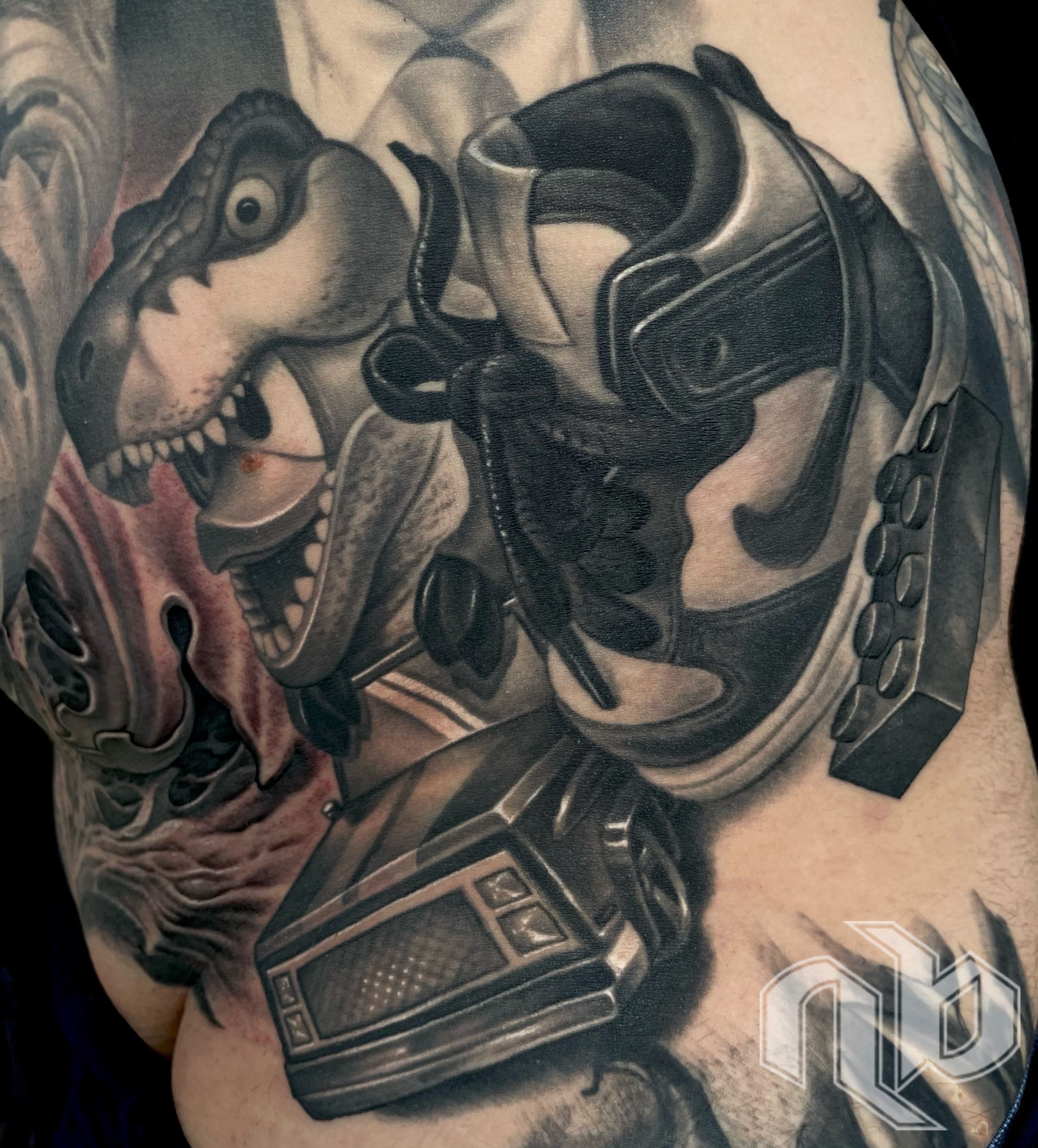 black and gray realism tattoo still life of child's shoe, lego brick and toy car with toy dinosaur by nick baxter in austin texas