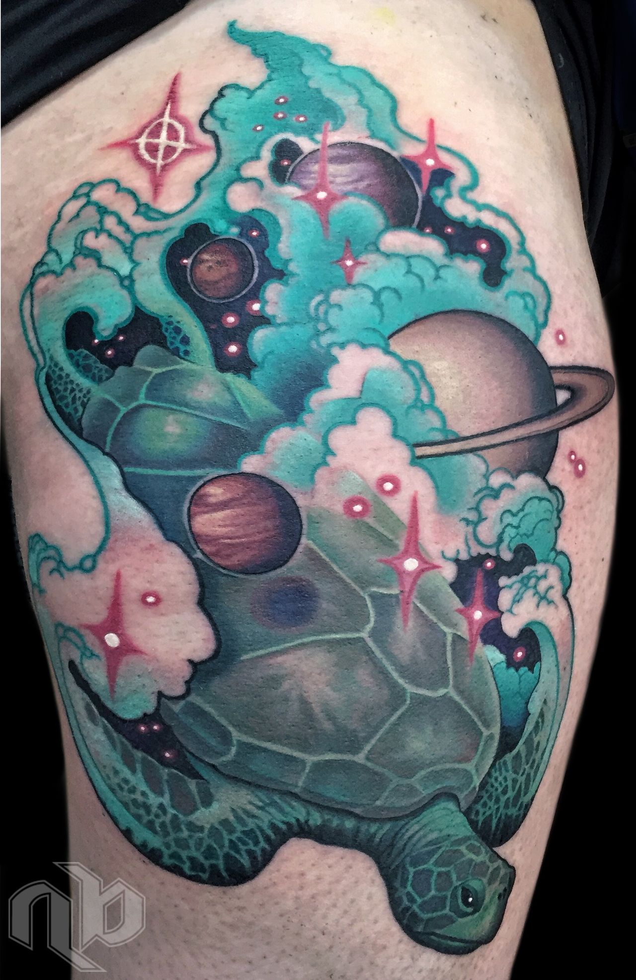 Close view of a teal sea turtle leg tattoo surrounded by curling clouds, planets, waves, and bright pink stars.