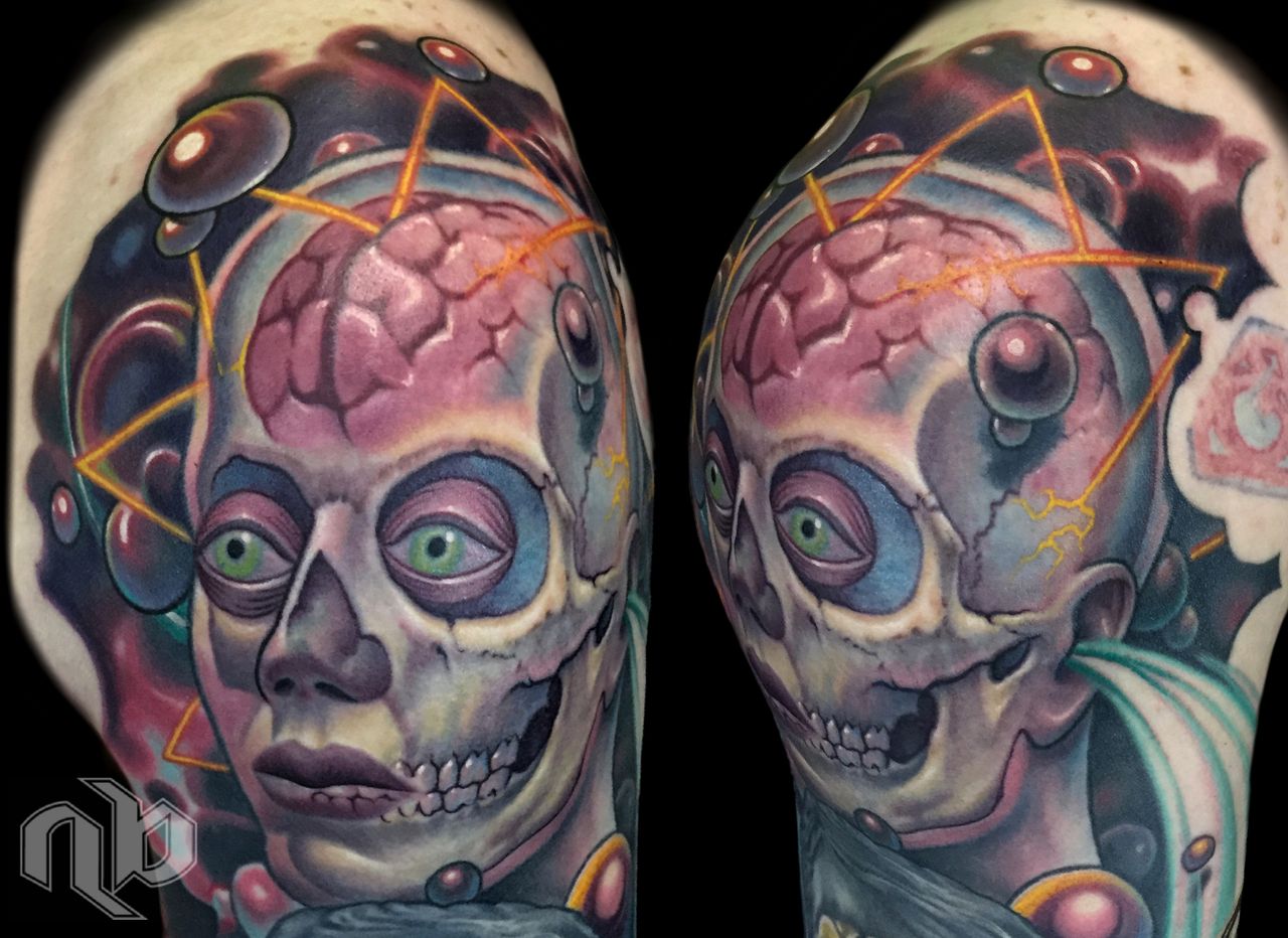 Two close views of a colorful arm tattoo show a skull-faced cosmonaut with exposed pink brain, green eyes, planets, and orange geometric lines.